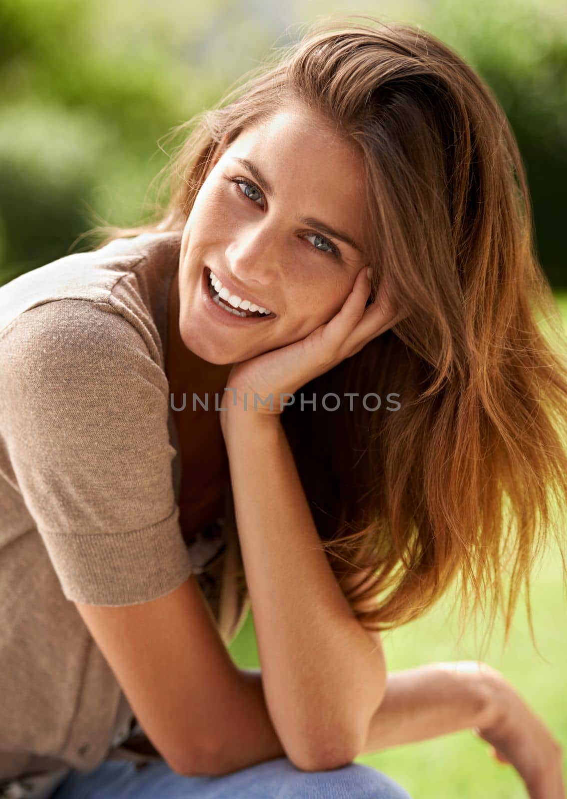 Smelling the sunshine and outdoors. a beautiful young woman relaxing in the outdoors