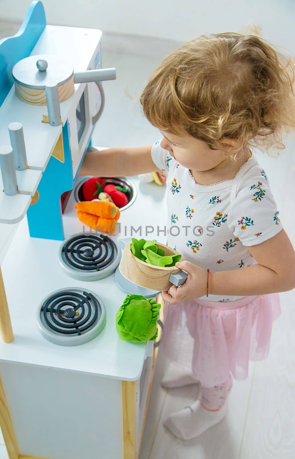 the child plays in the kitchen and cooks. Selective focus. Kid.