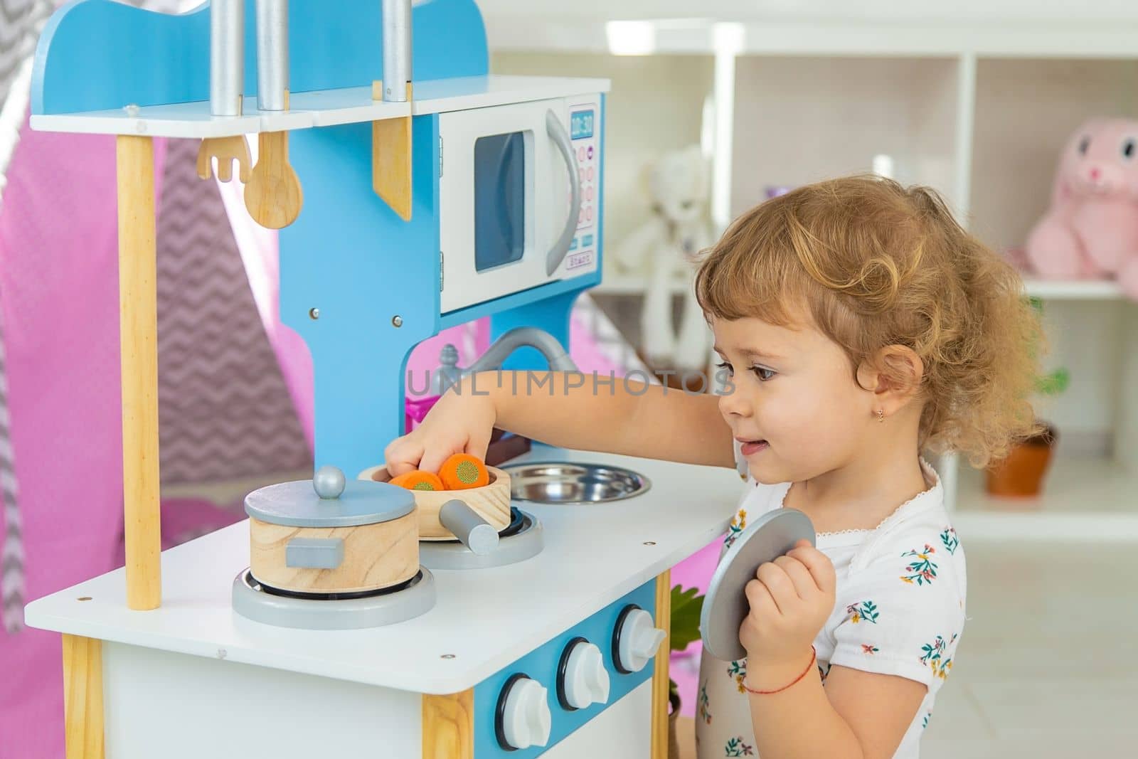 the child plays in the kitchen and cooks. Selective focus. Kid.