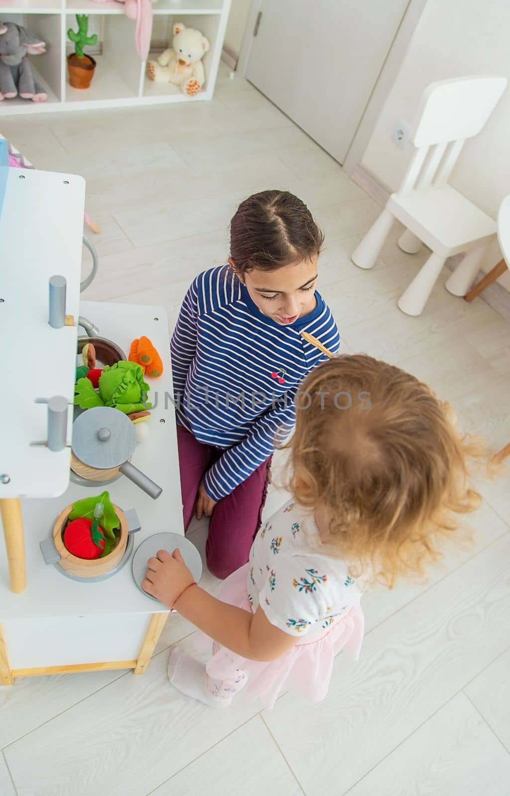 the child plays in the kitchen and cooks. Selective focus. by yanadjana