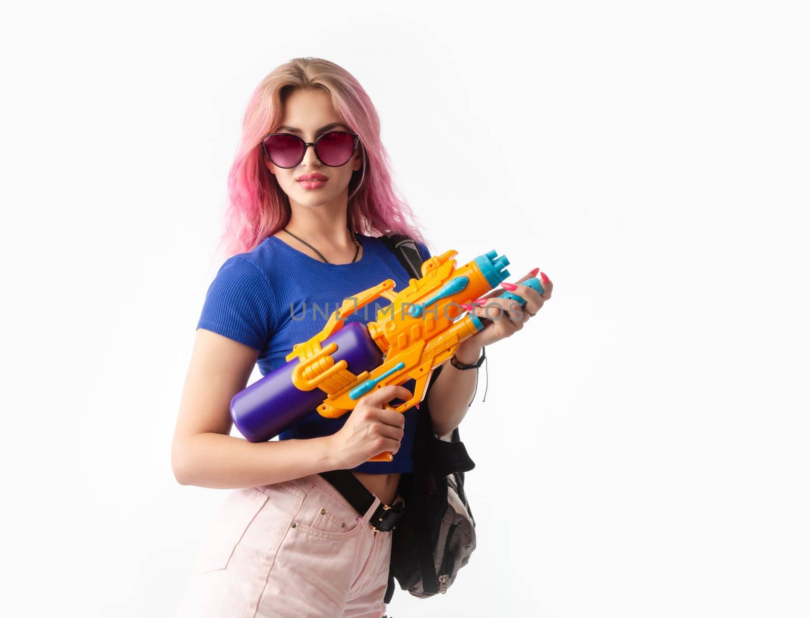 girl with a water gun in summer clothes, slim and sexy isolated on a white background by Rotozey