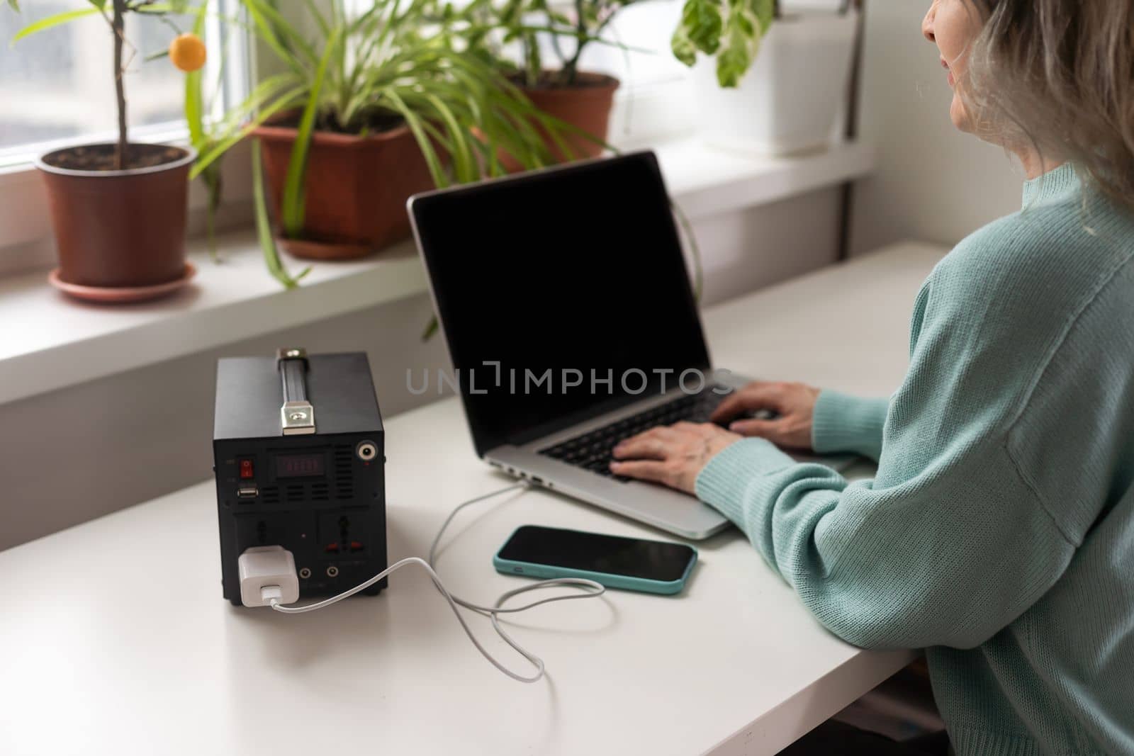 Charging station for phone, tablet, laptop and other gadgets when there is no light during blackout. Generator power bank battery in the absence of electricity. Charge electric rechargeable battery