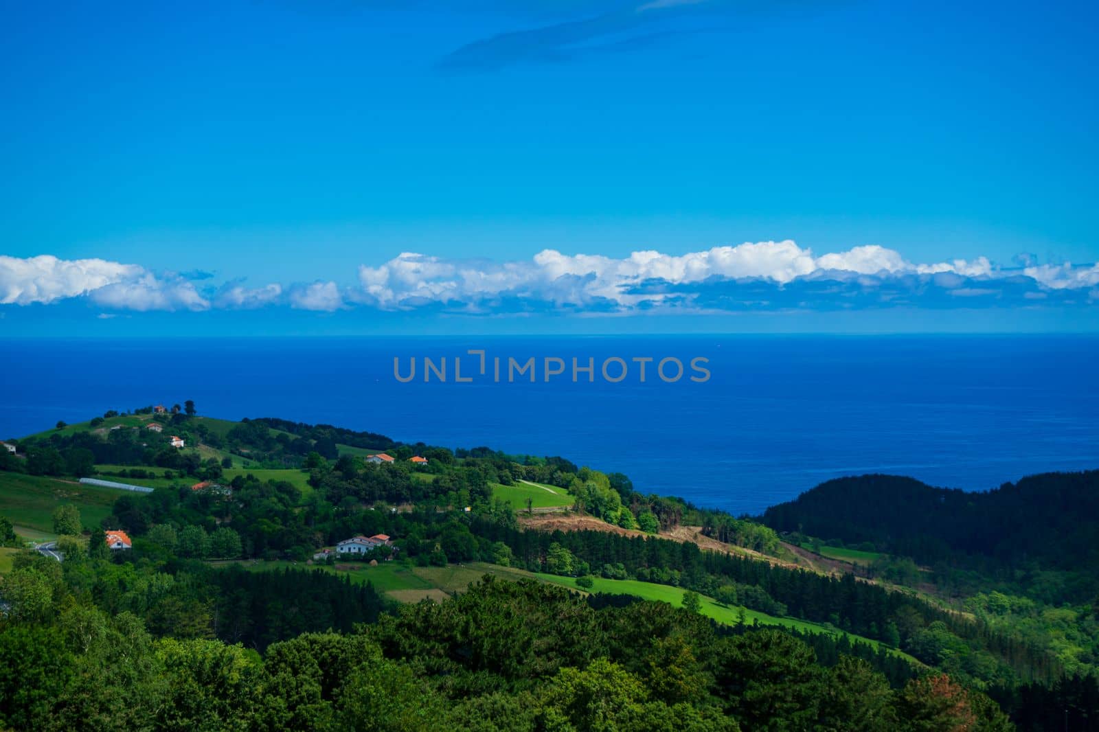 Landscape overlooking the green hills and the Atlantic Ocean. Coast of Basque Country, Spain by paca-waca