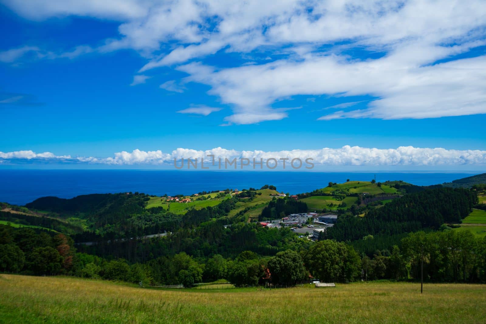Landscape overlooking the green hills and the Atlantic Ocean. Coast of Basque Country, Spain.