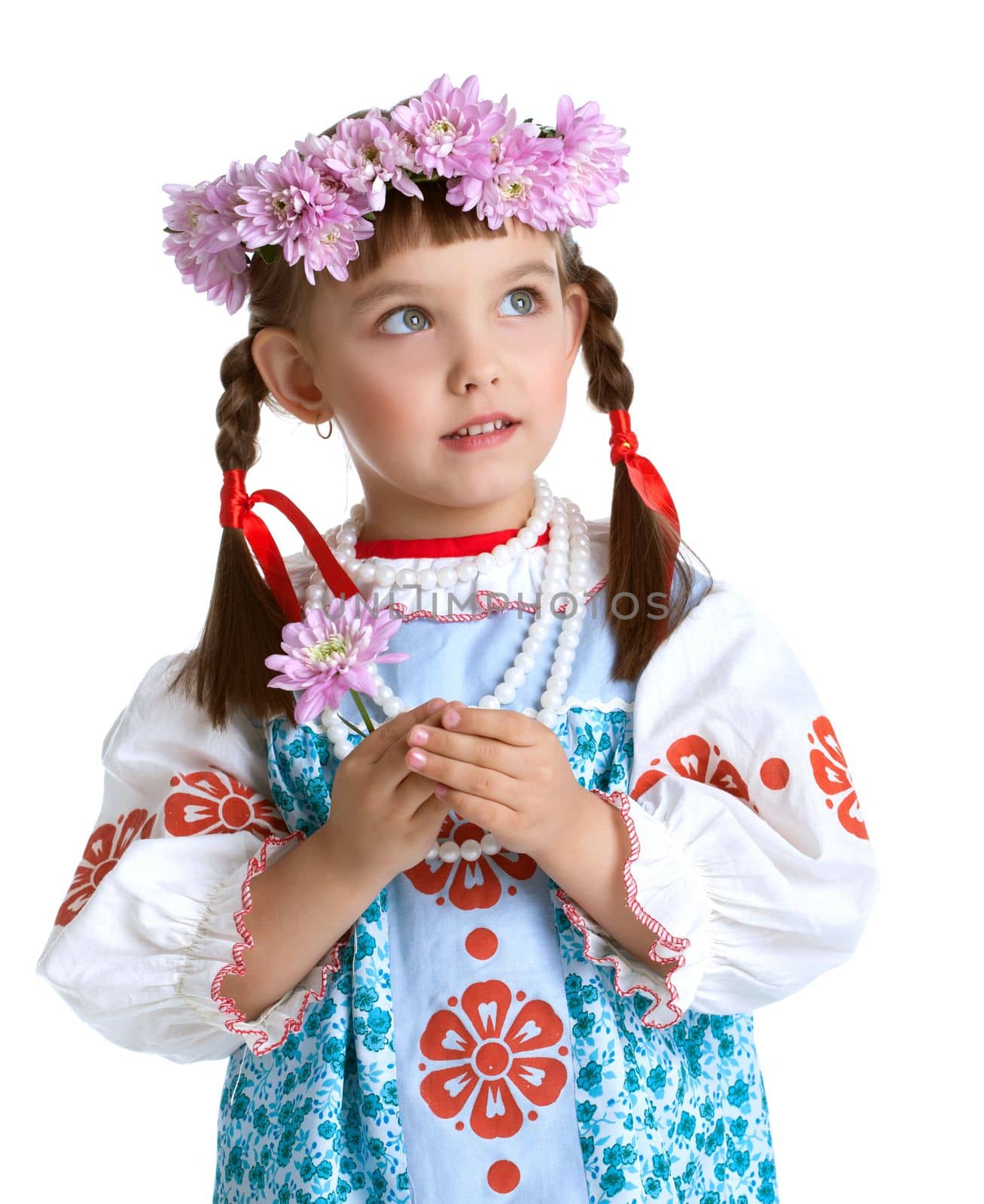 Portrait of cute little girl in slavic costume and wreath of flowers. Isolated on white