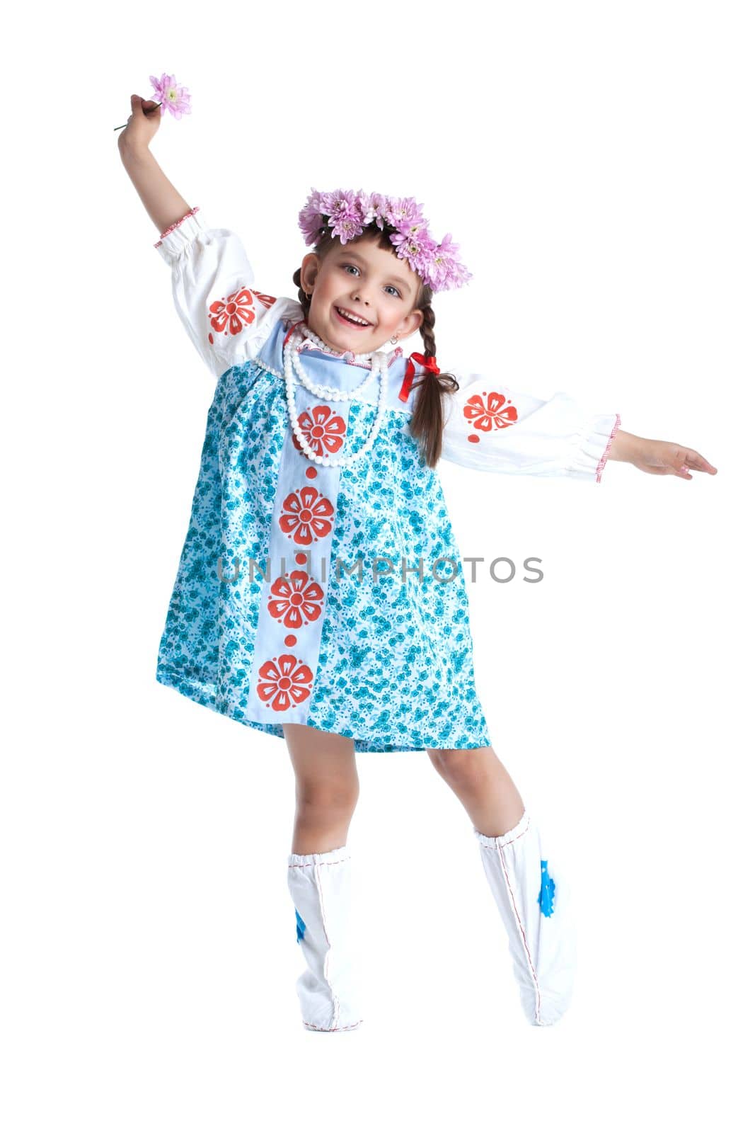 portrait of happy little girl in slavic costume and garland of flowers. Isolated on white