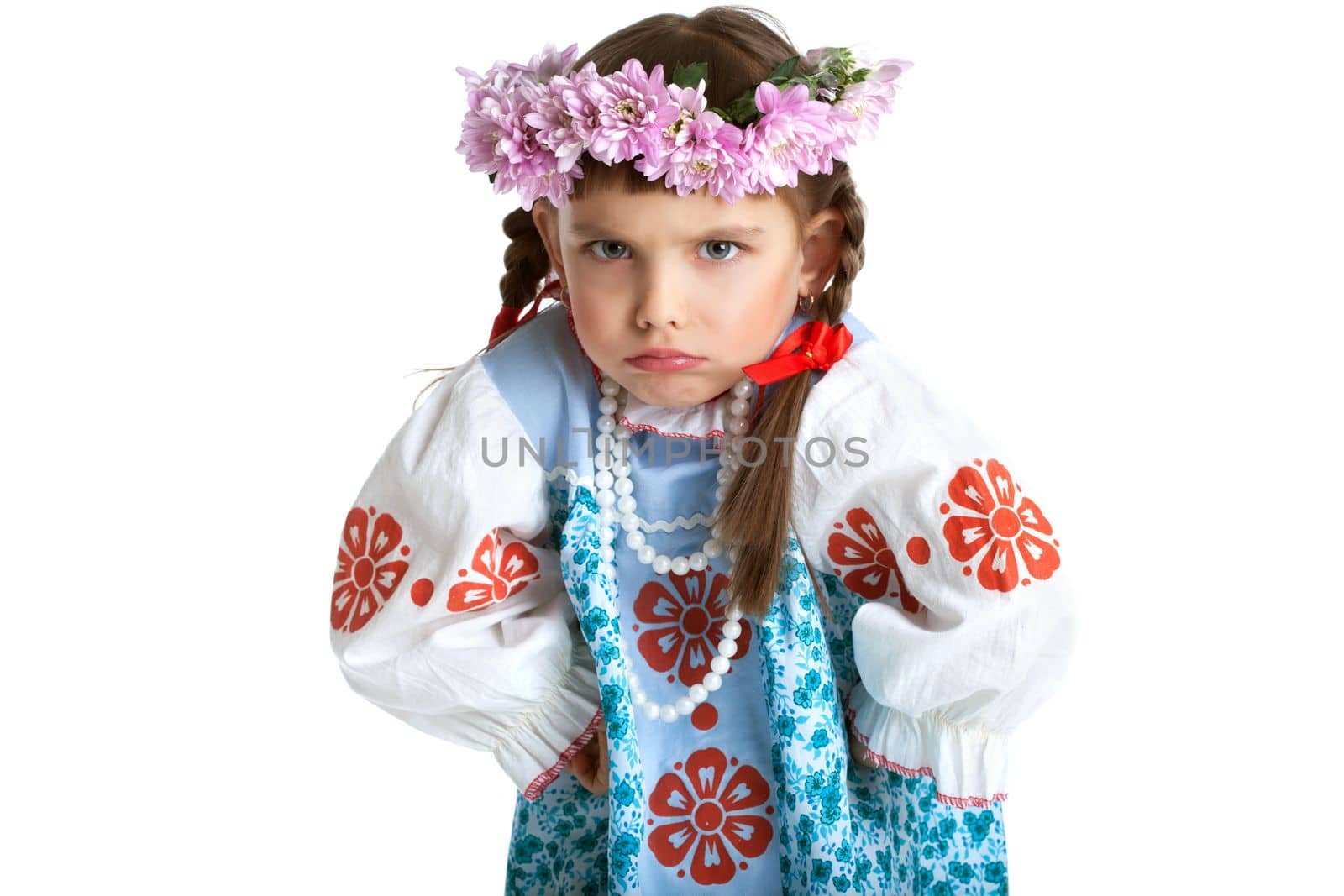 Portrait of little girl in slavic costume and wreath of flowers. Isolated on white