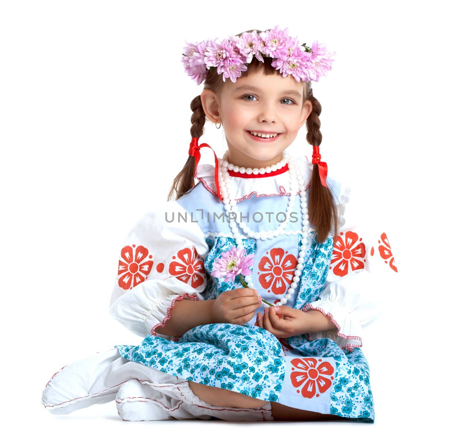Portrait of little girl in slavic costume and wreath of flowers. Isolated on white