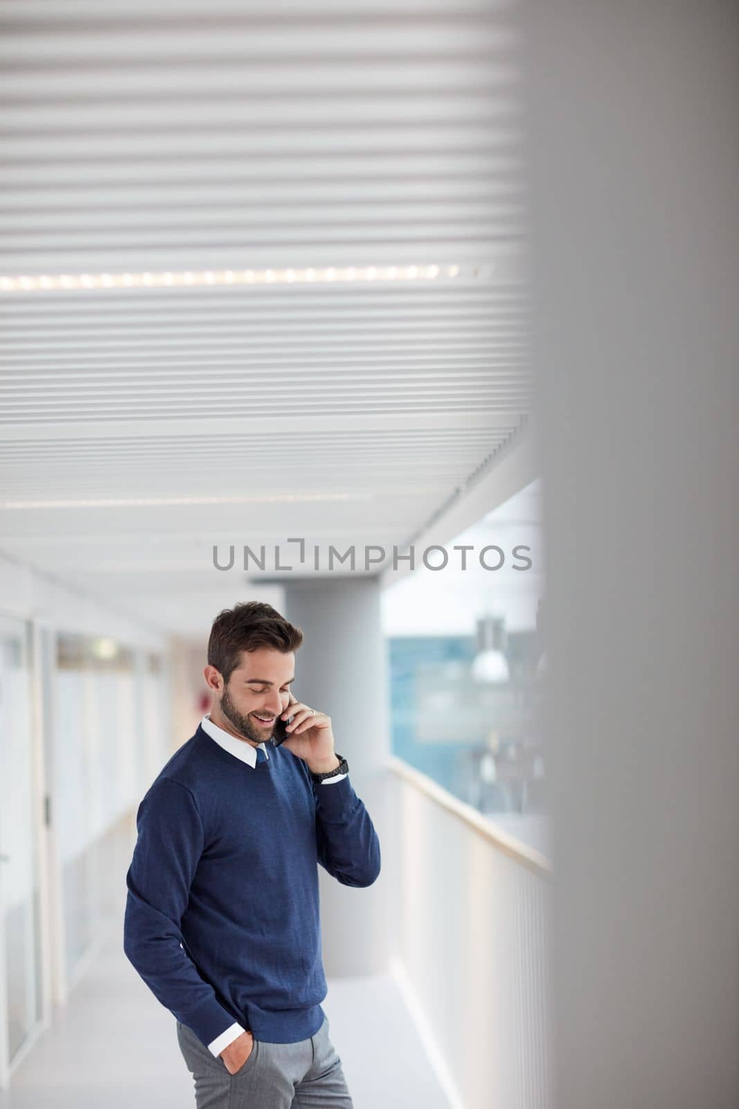 Technology ensures he stays within reach of success. a young businessman talking on a cellphone in an office