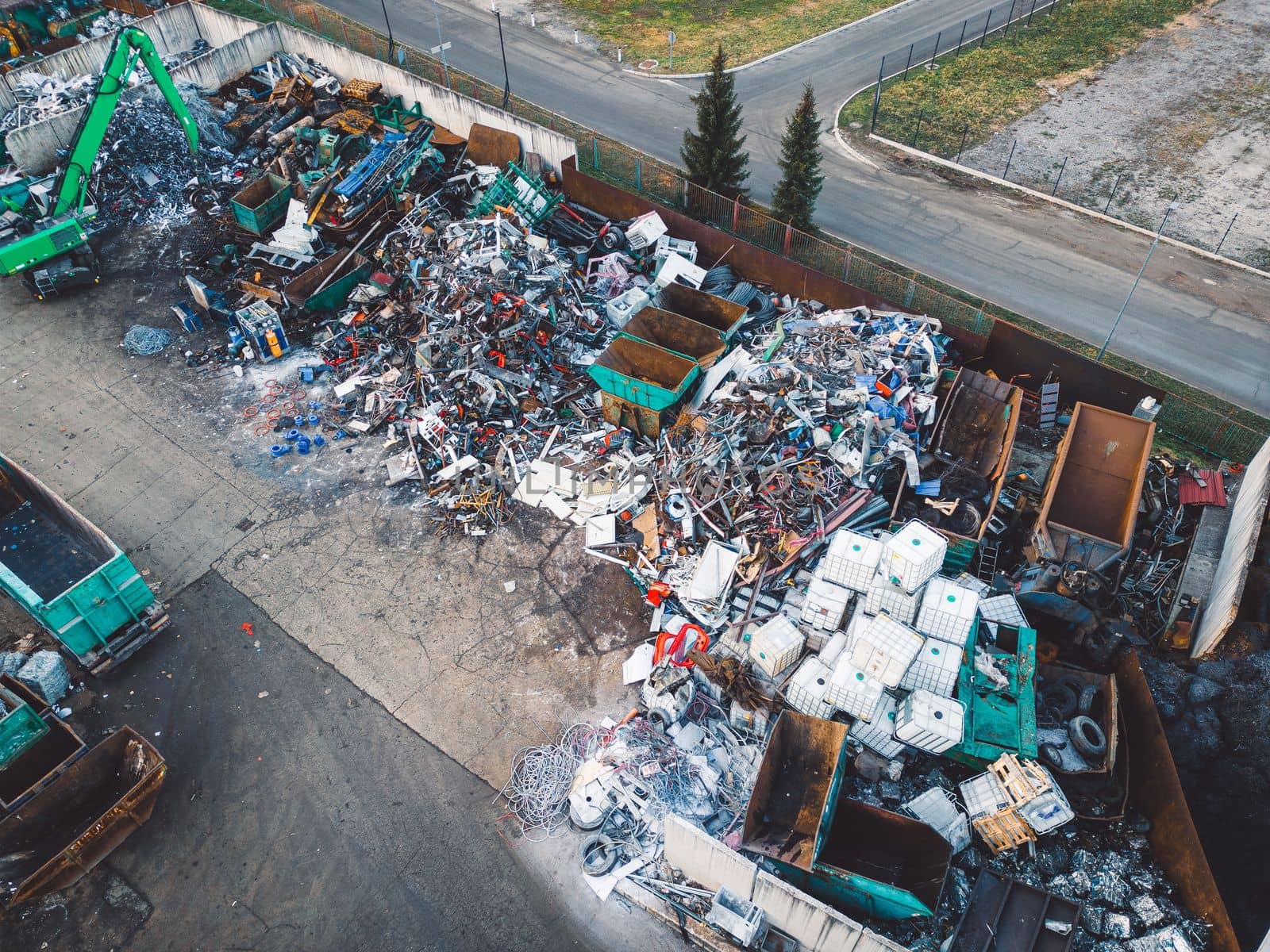 Aerial view, drone shoot of recycling center, containers for sorting out different garbage materials. Excess garbage problems. Reduce, reuse, recycle.