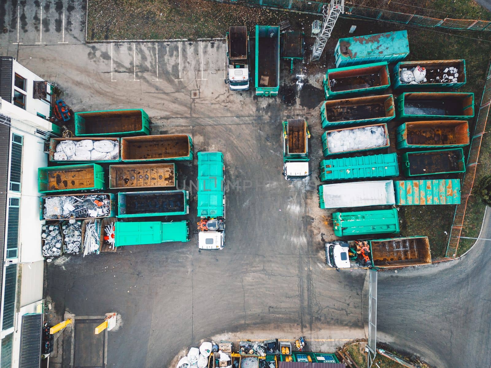 Aerial view, drone shoot of recycling center, containers for sorting out different garbage materials. Excess garbage problems. Reduce, reuse, recycle.