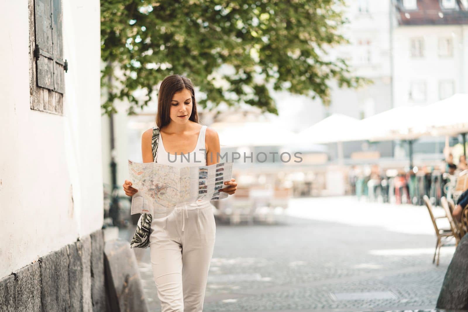 Young caucasian woman doing errands around the city, shopping at the market, going for lunch, walking around the city and enjoying a beautiful sunny day.