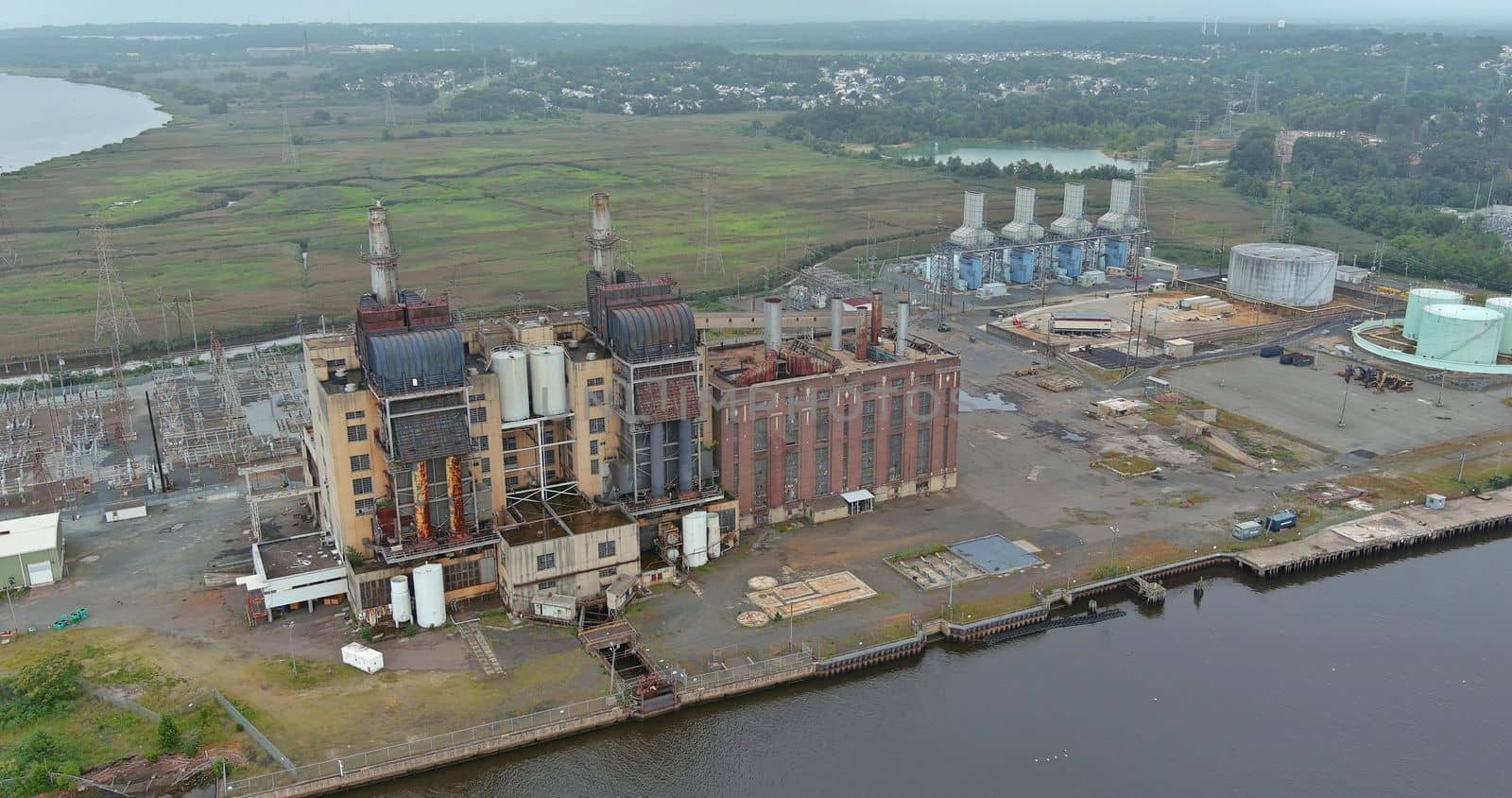 Old thermal power station located on coast of bay in process of being decommissioned