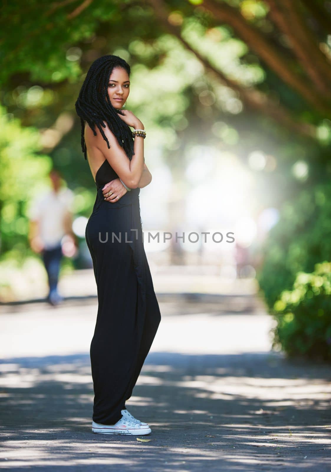 Her style is right on trend. Portrait of an attractive young woman posing outdoors. by YuriArcurs