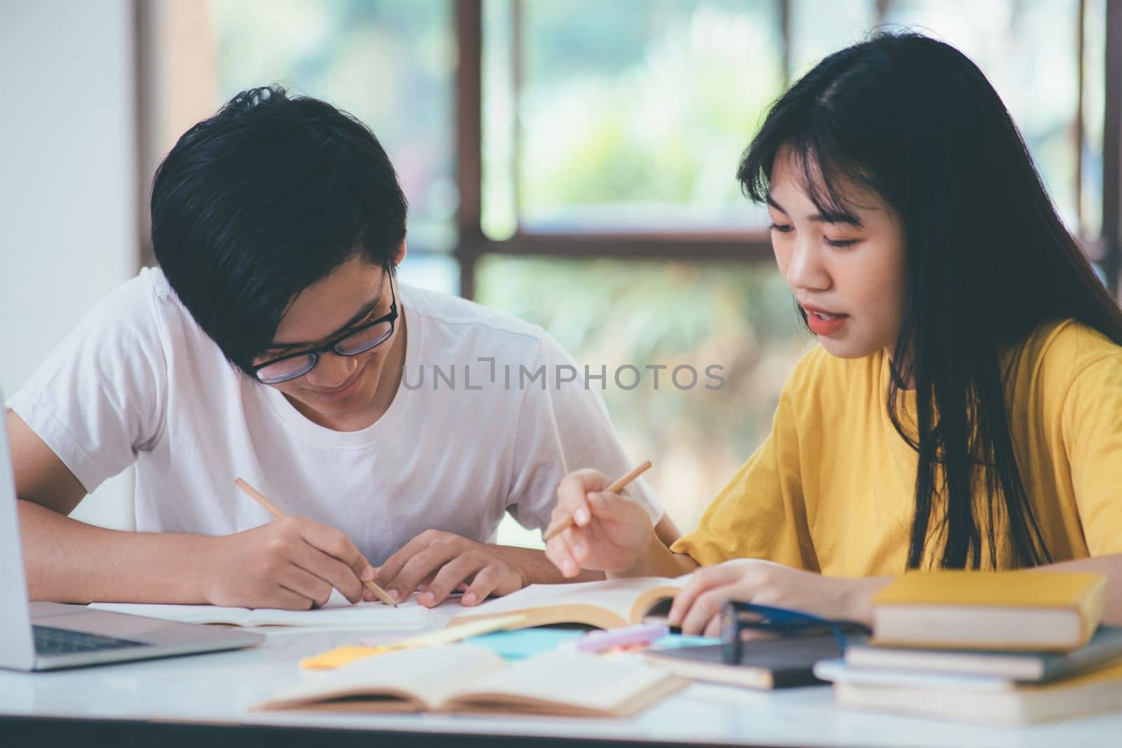 An asian students are reading books and study, Tutoring together. by ijeab