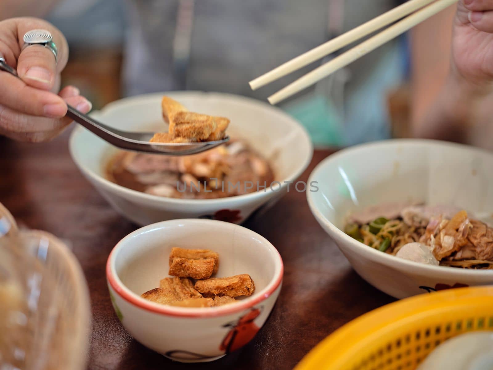 Thai Boat noodles in thicken soup added blood with Pork balls, Sliced beef and liver serve and crispy fried pork skin.