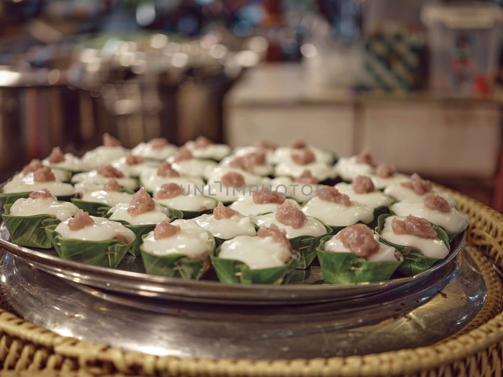 Thai desert ,Famous Thai Pudding with Coconut topping on banana leaf(Tako)