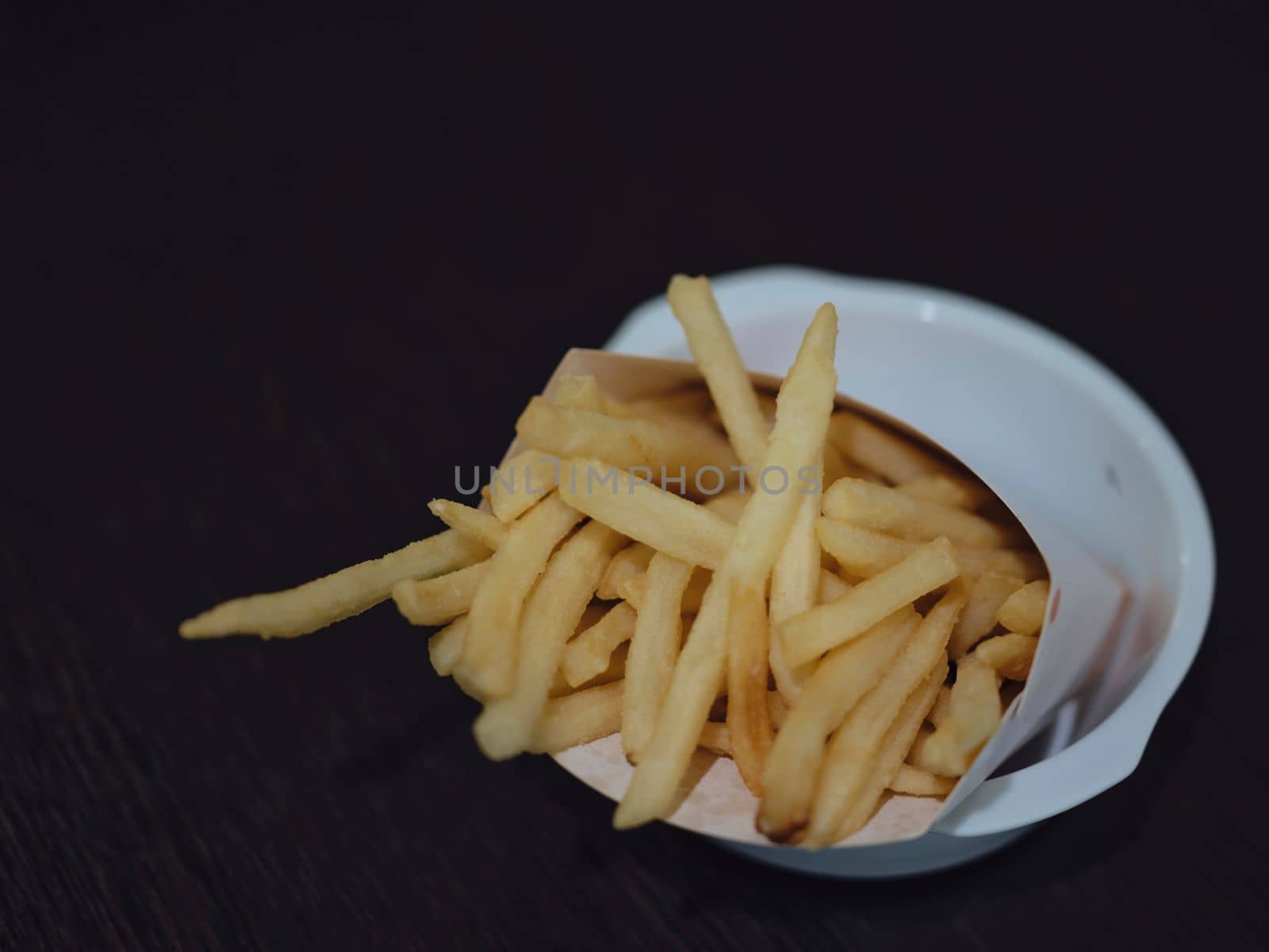 french fries or potato fry on  black wood . copy for space by Hepjam