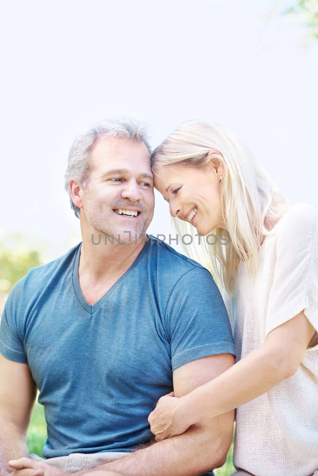 Sharing a sense of humor. A happy mature couple spending time with each other outdoors. by YuriArcurs