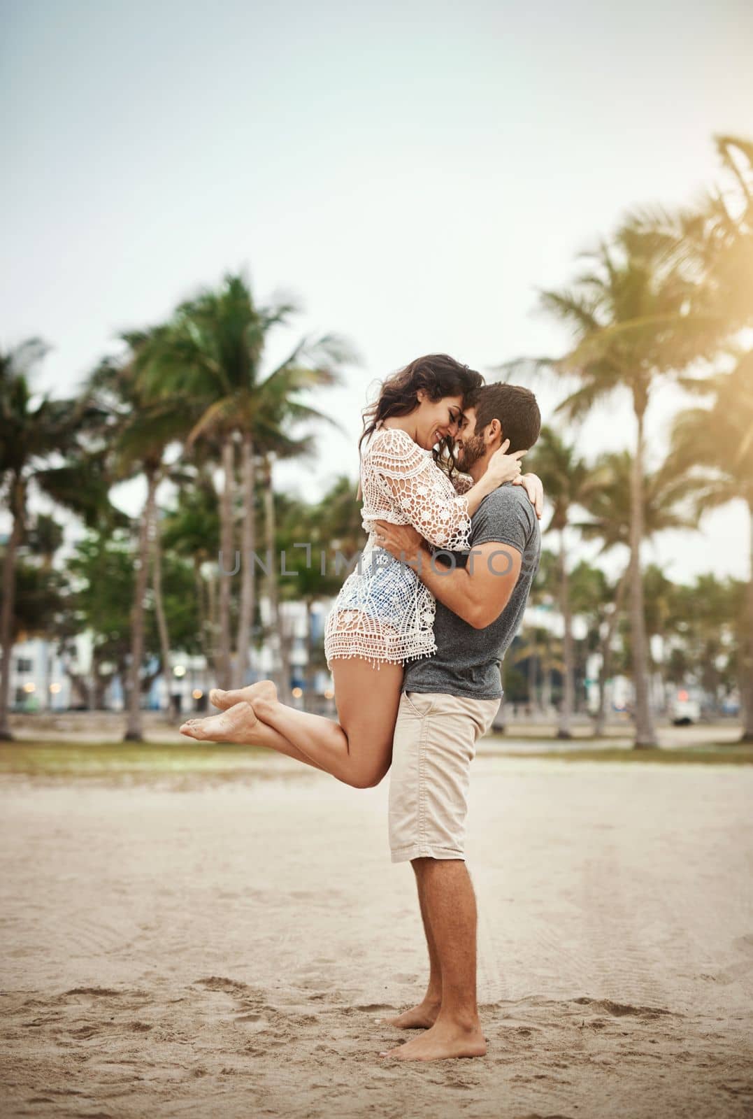 Im madly in love with. a young couple spending a romantic day at the beach. by YuriArcurs