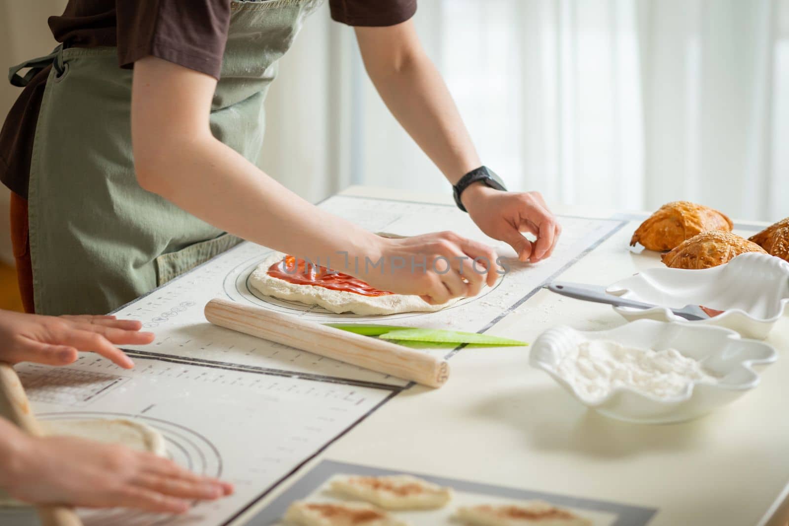 Cooking desserts in a large kitchen by two chefs on silicone kitchen mats.
