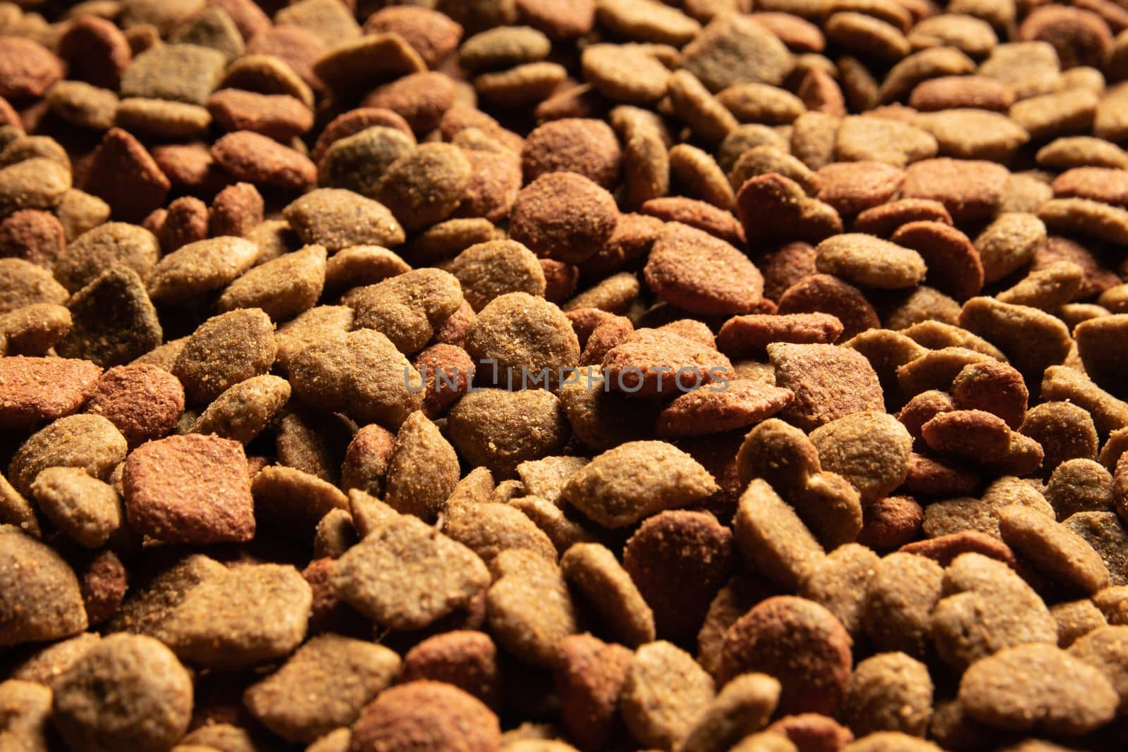 Close-up of a pile of brown colored dog food background.