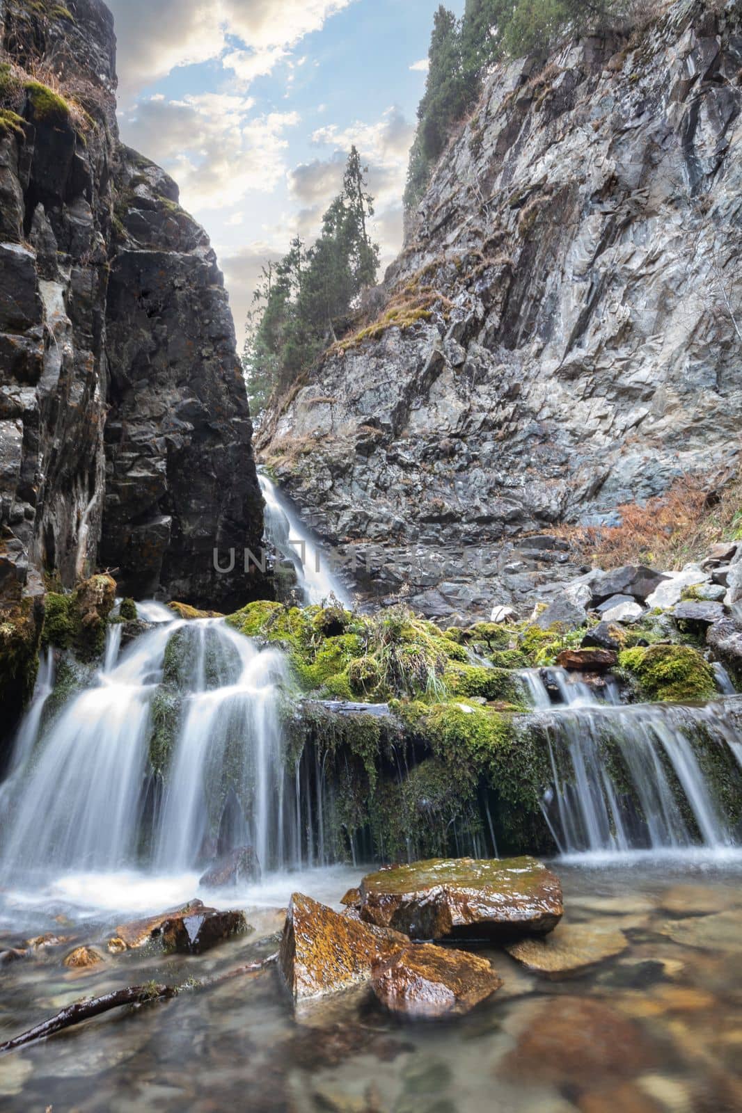 Bear waterfall 2 in Big Almaty gorge of Almaty mountains, ile alatau parkland, picturesque nature of central Asia, vertical.