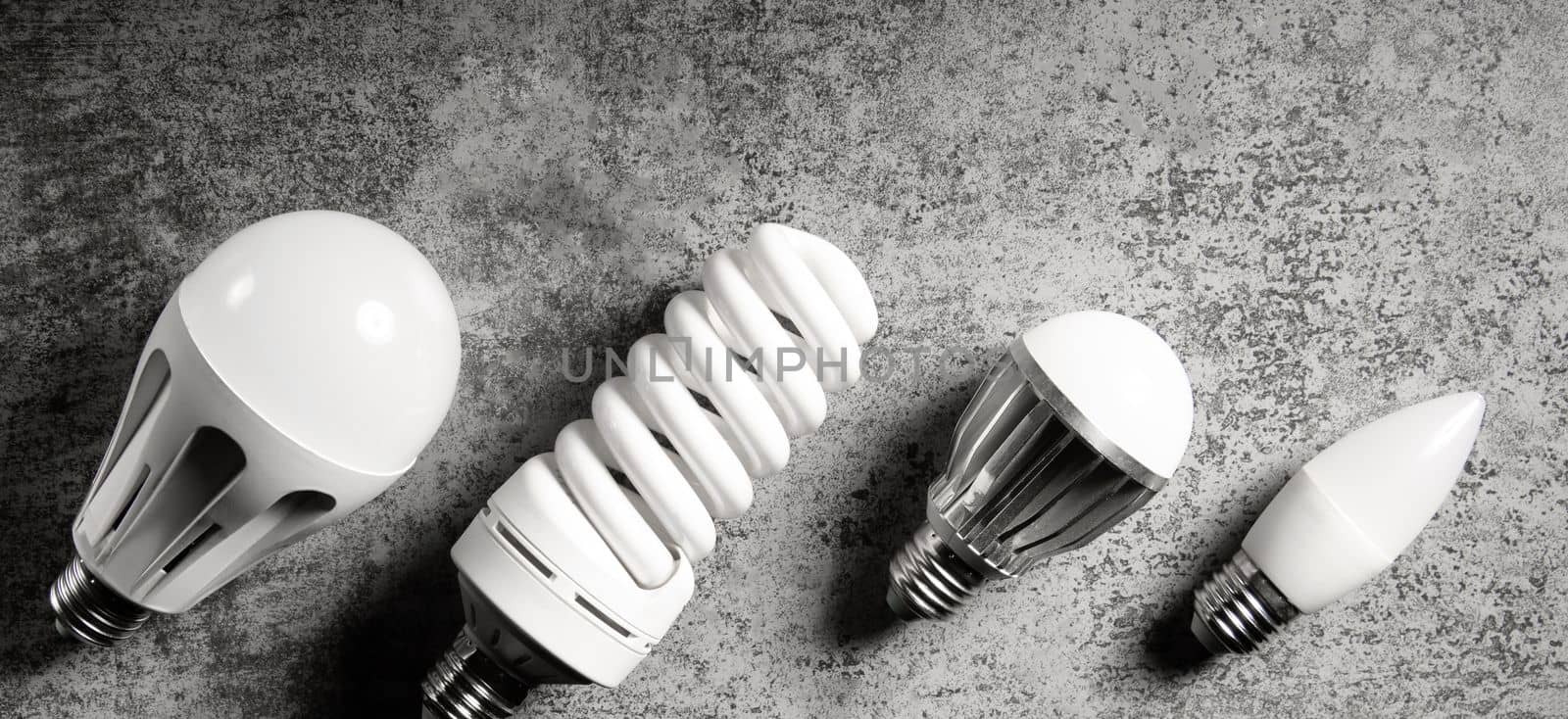 Various household lamp bulbs with e27 base on gray background.