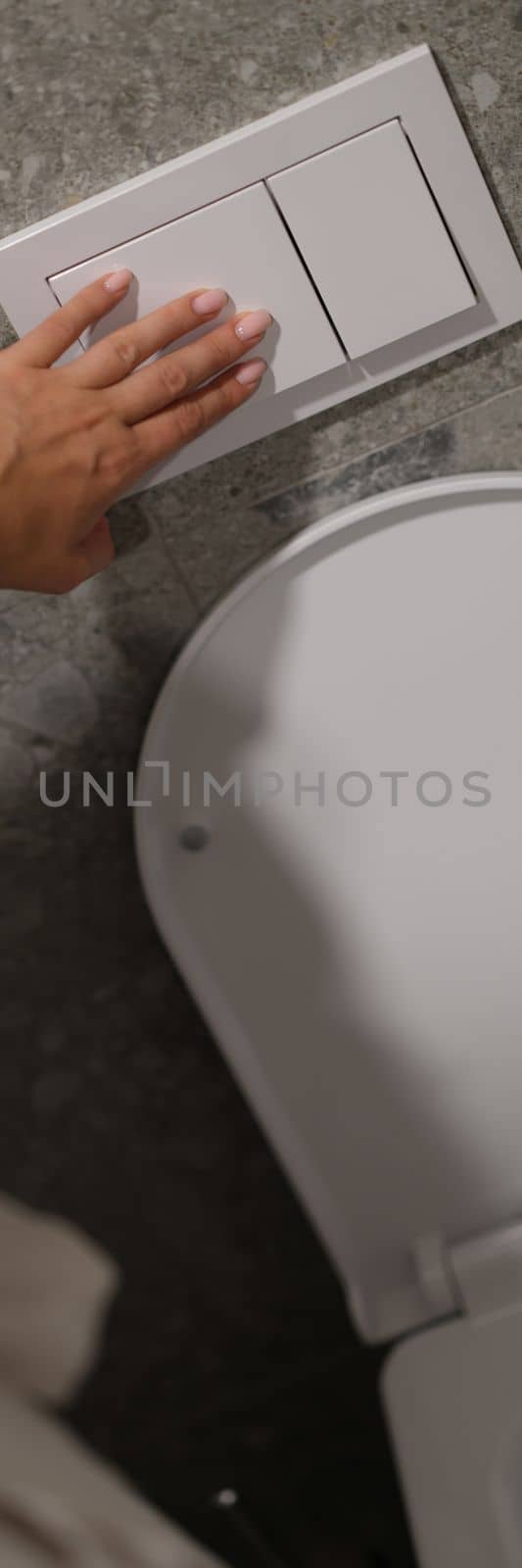 Economical toilet flush button with two separate buttons in white. Double flush toilet bowl concept