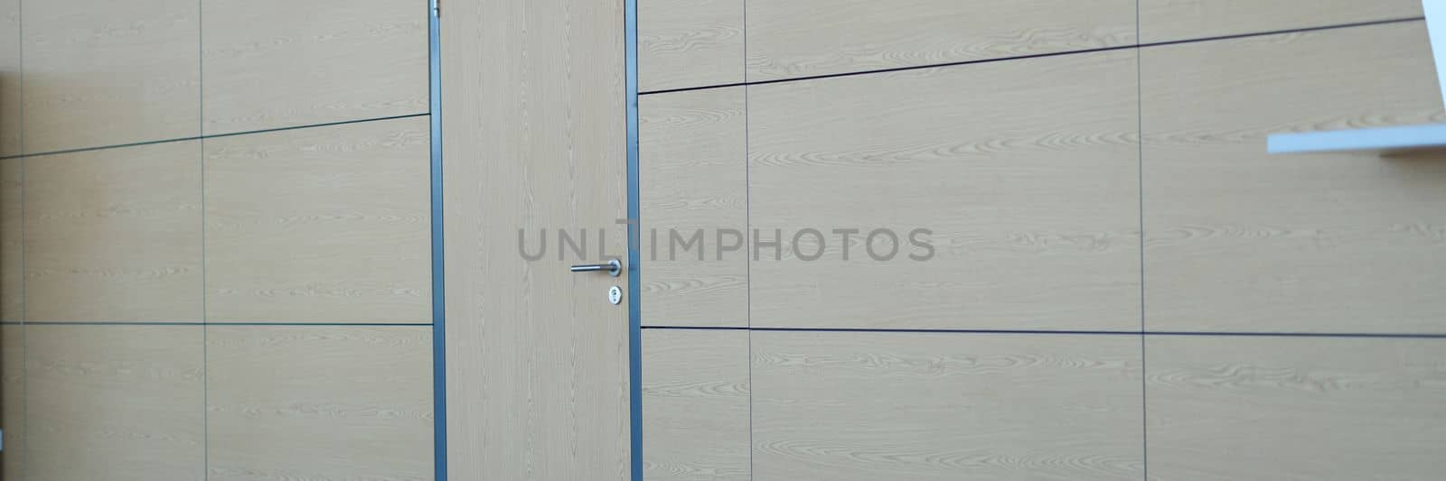 Light brown door and wall in building of airport station or business center. Stylish fashionable loft design in business centers