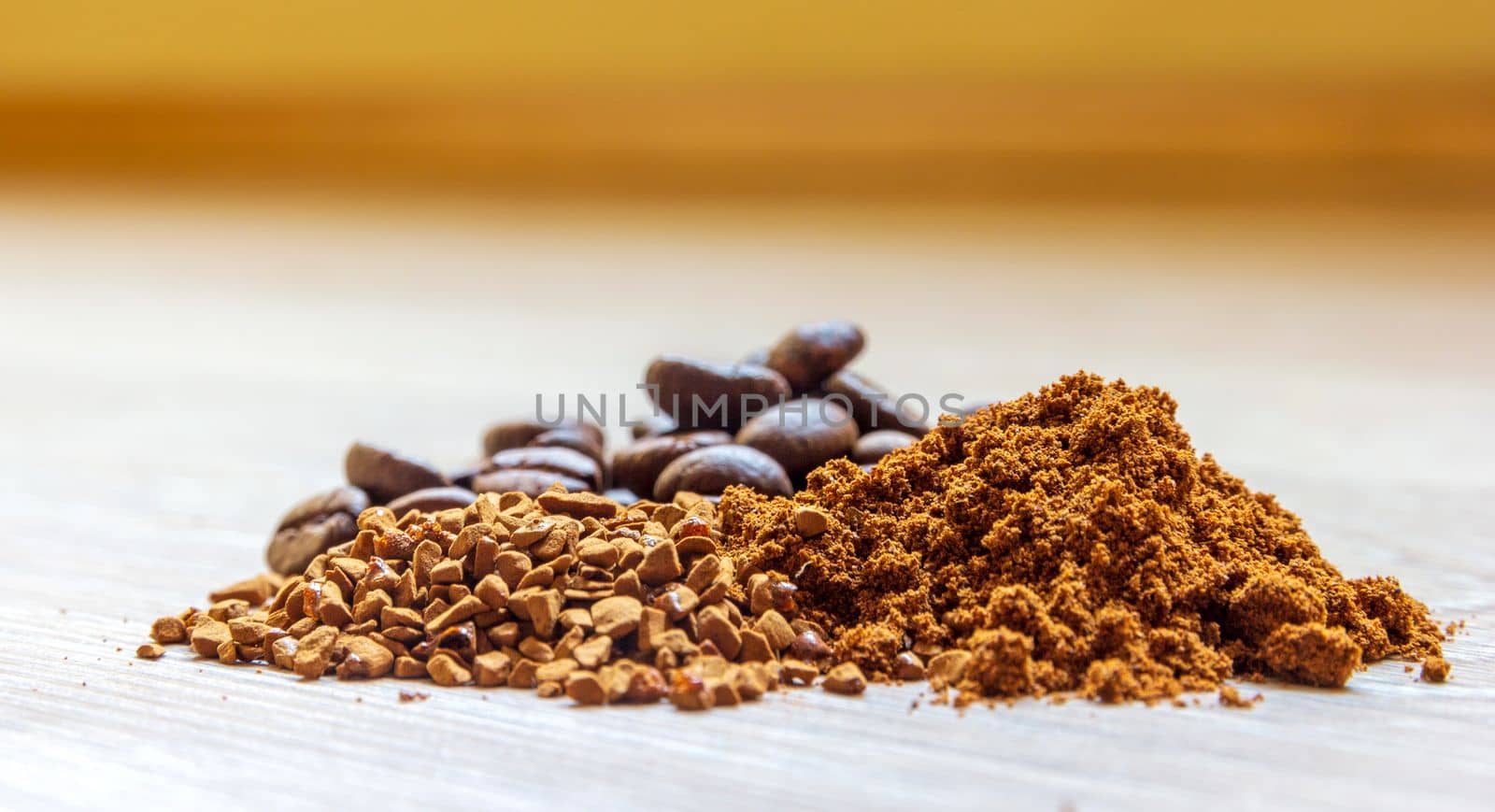 Close view of heaps of fine grinding coffee powder, coffee beans and instant coffee