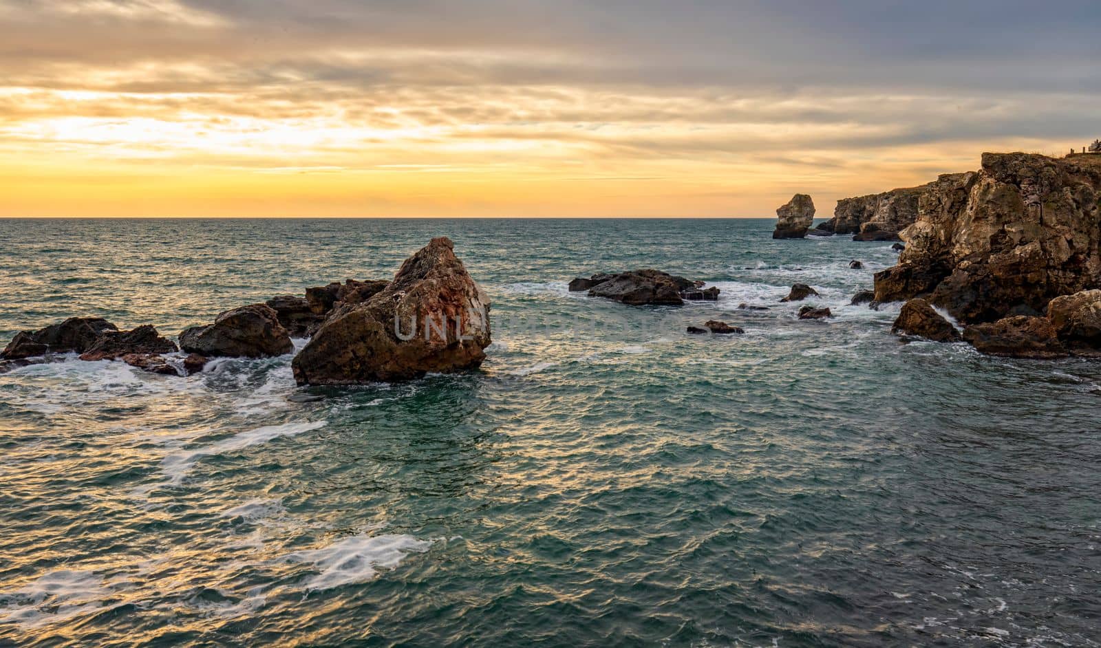 Beautiful cliffs of the Black sea. Rocks among the sea waves.