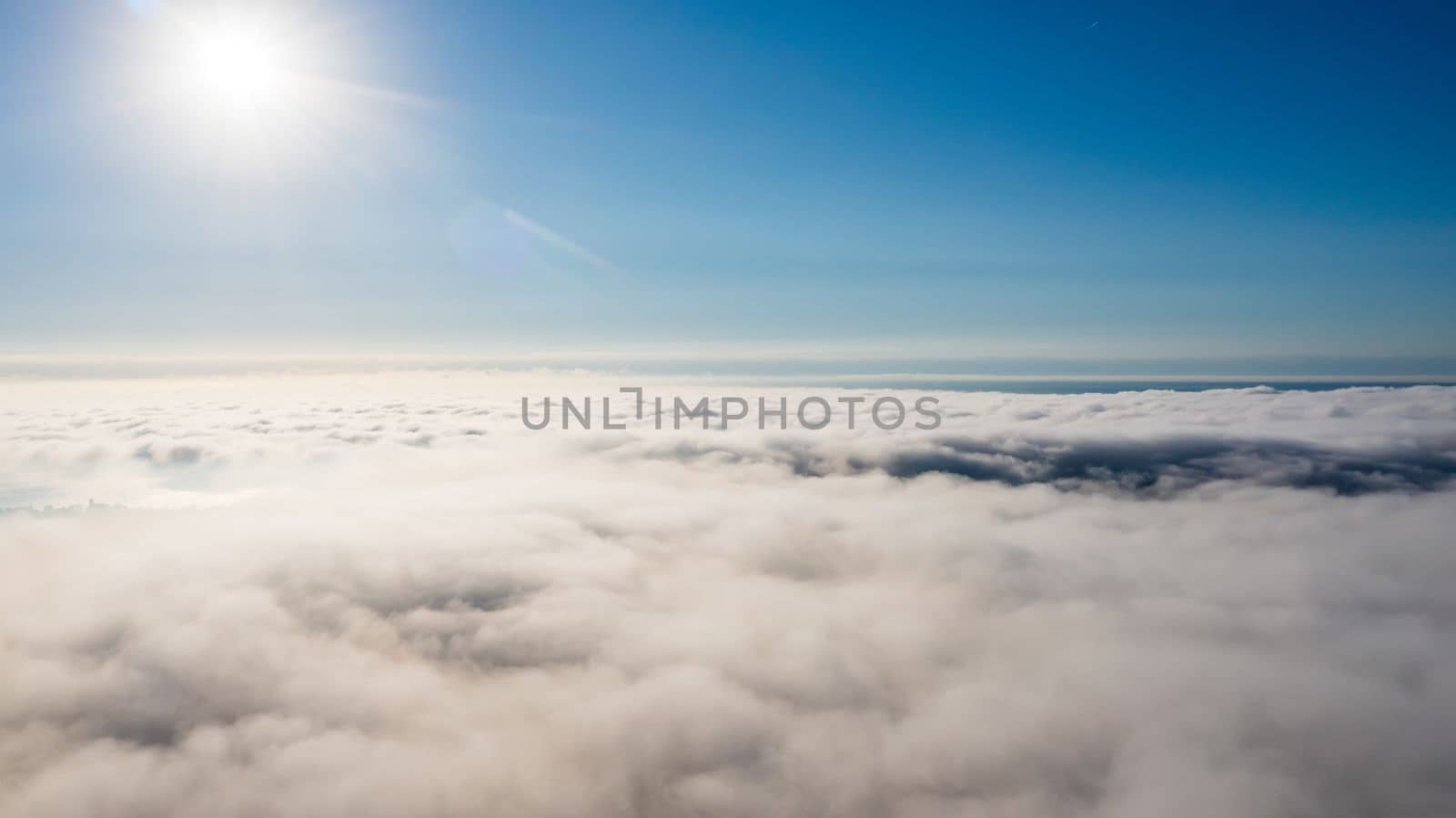 Sun over city fog, view from above