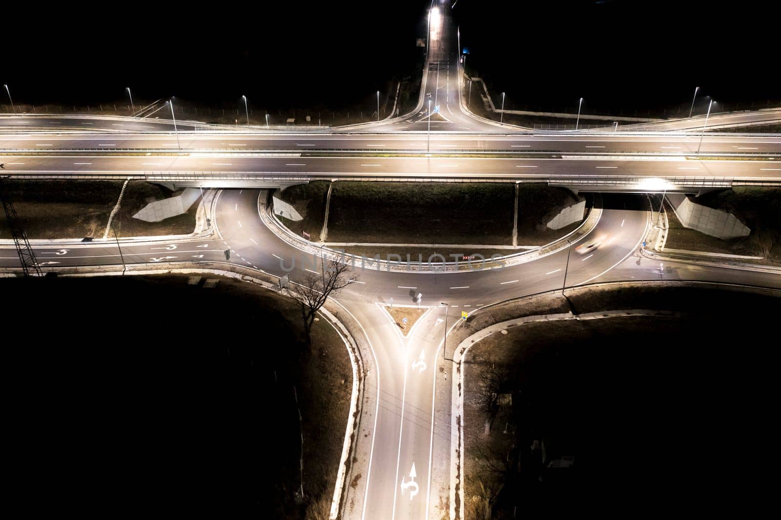 Aerial view of urban highway intersection road in the night light.