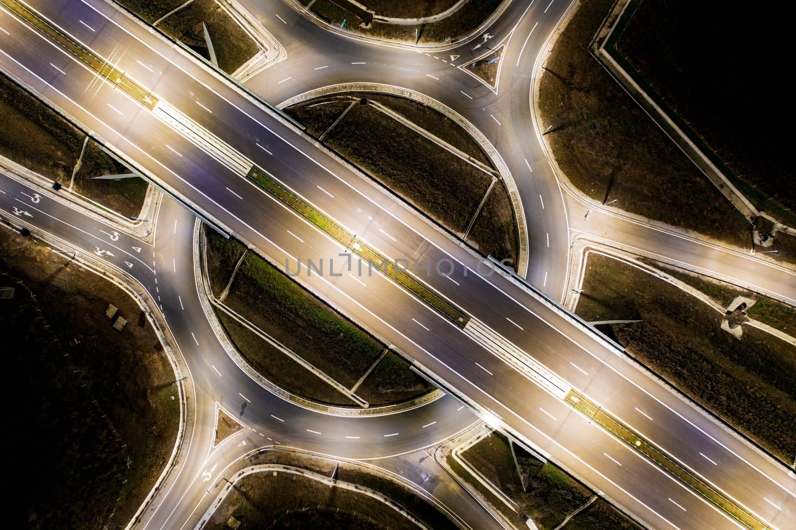 Aerial view of urban highway intersection road in the night light.