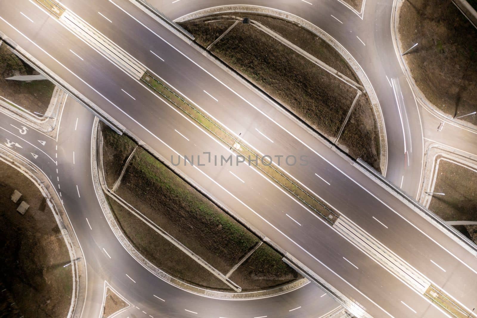 Aerial view of urban highway intersection road in the night light.