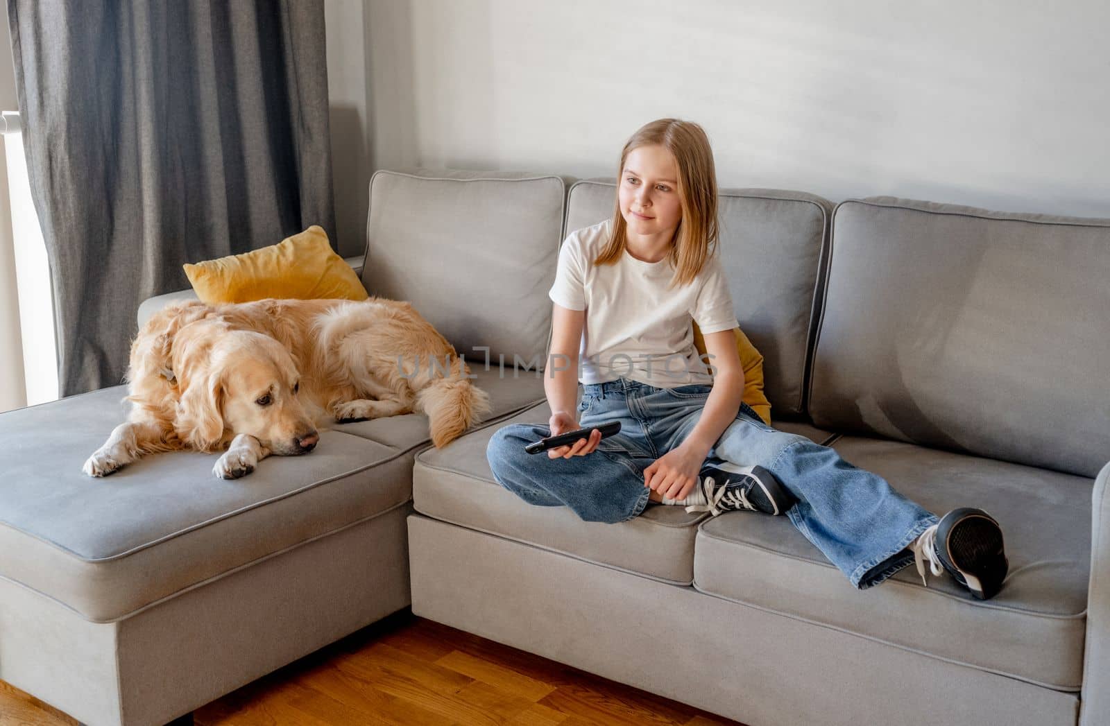 Preteen girl with golden retriever at home by tan4ikk1
