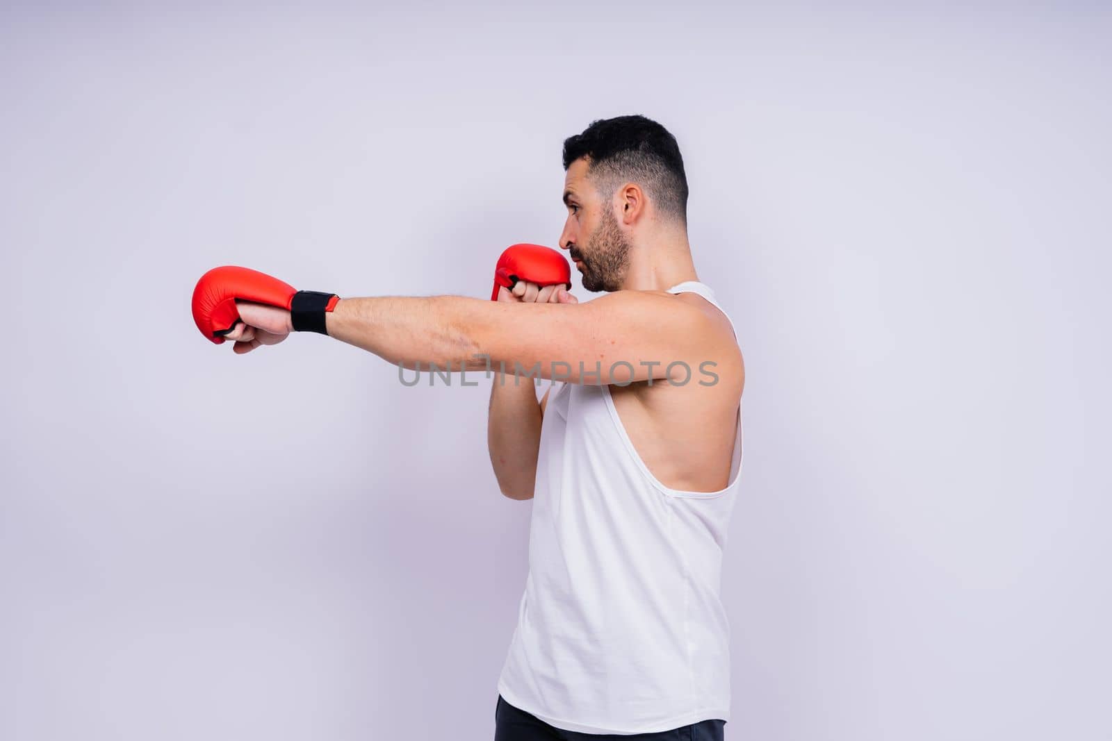 Young caucasian handsome man isolated on white background with boxing gloves by Zelenin