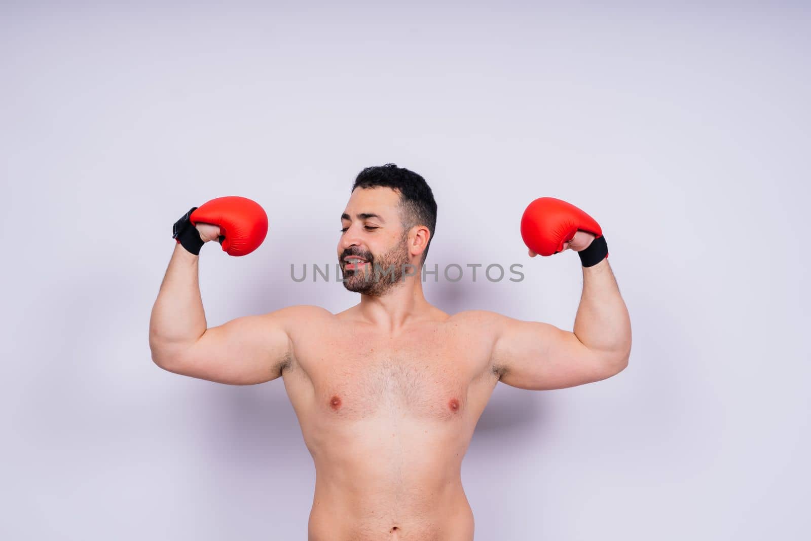 Young caucasian handsome man isolated on white background with boxing gloves by Zelenin