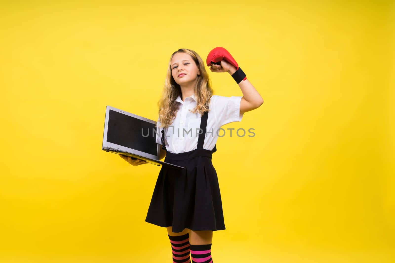 Little happy blonde kid girl 12-13 years laptop computer. Children lifestyle childhood concept.