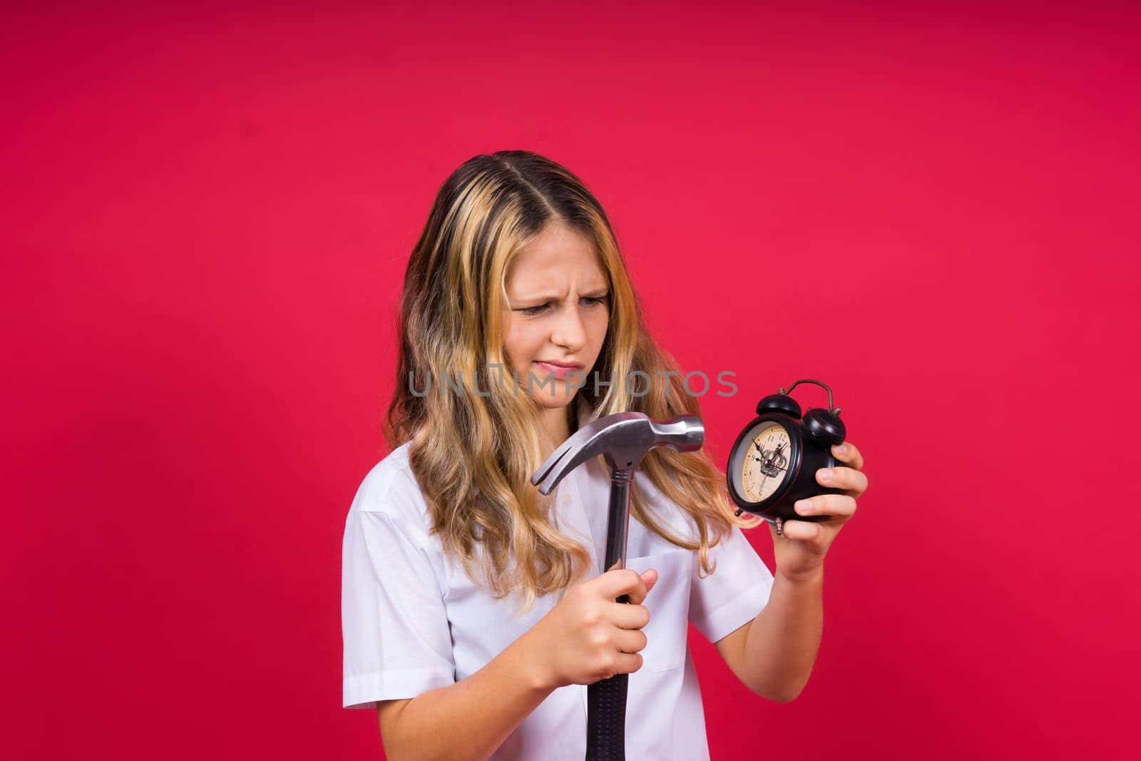 Teen girl 12, 13, 14 years old look at alarm clock. Good morning, checking time. Positive emotions. by Zelenin