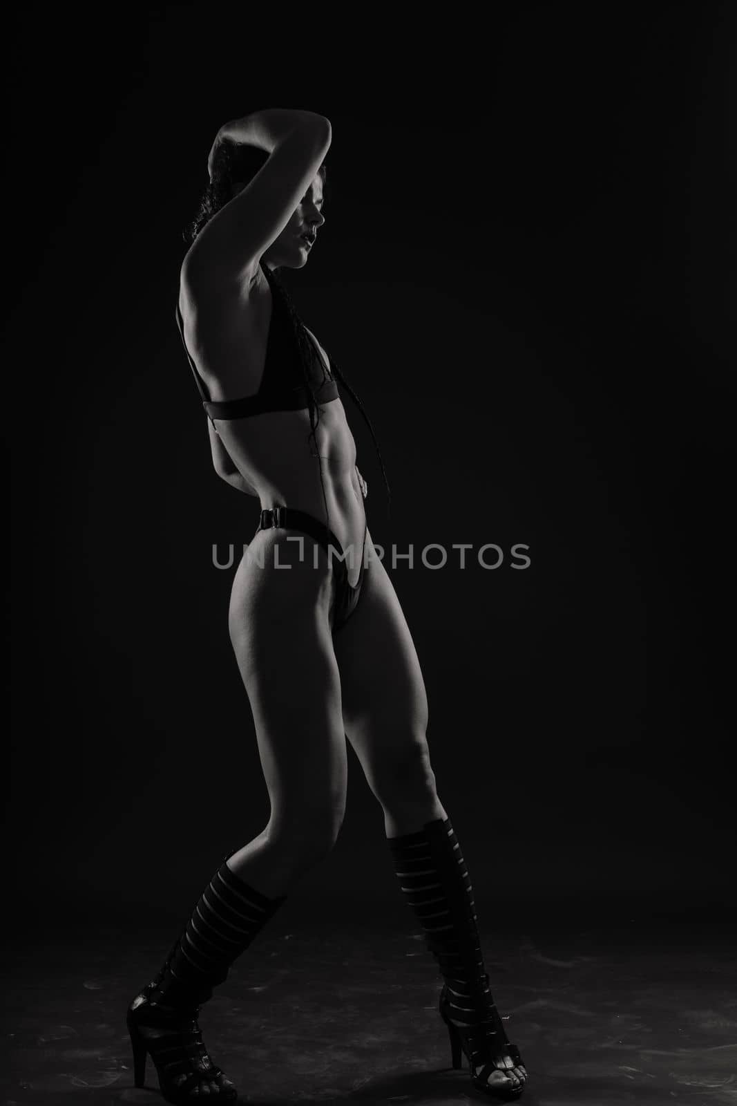 Close-up shot of young woman waist with muscular abdominal muscles. Abs of fit female athlete. by Zelenin