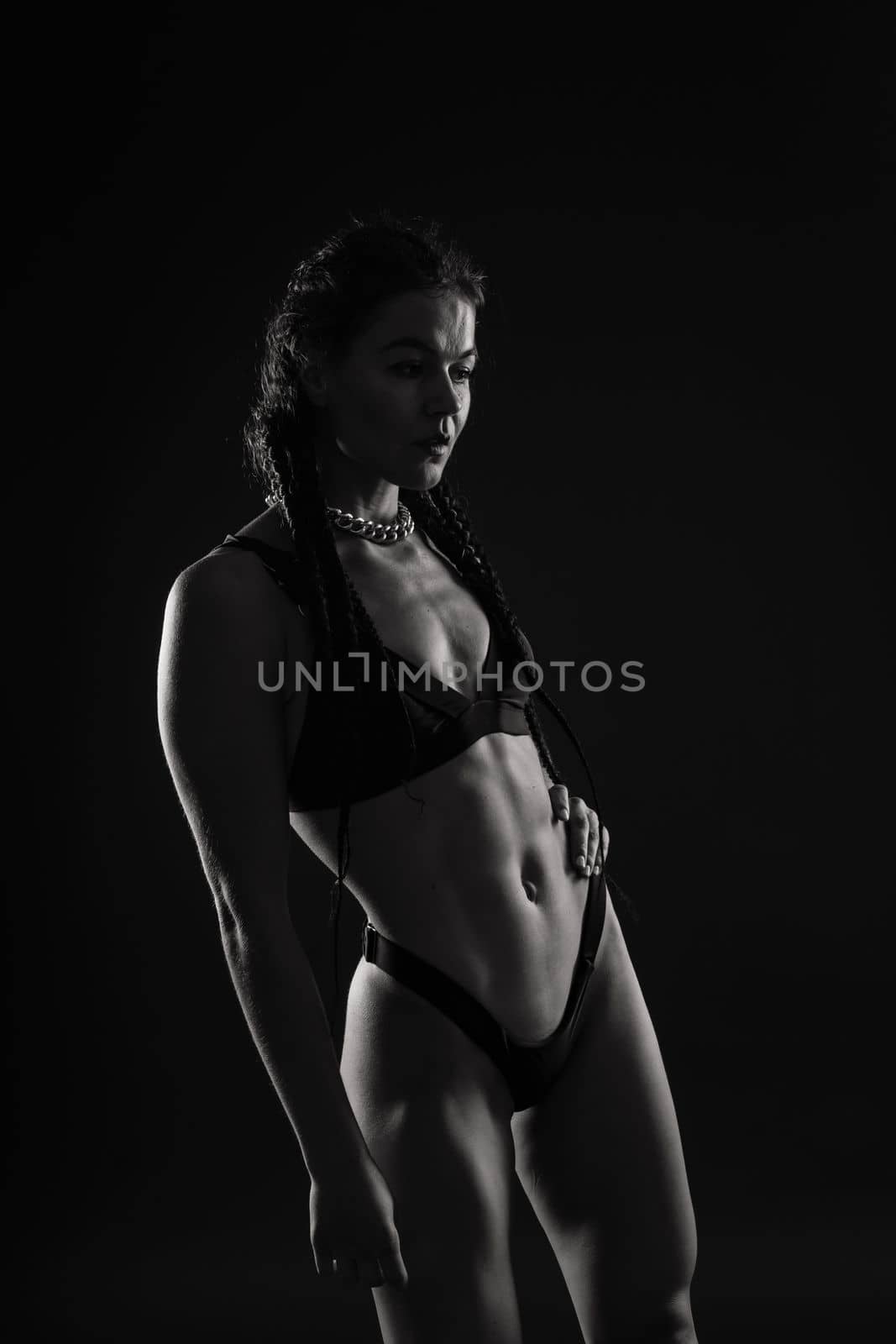 Close-up shot of young woman waist with muscular abdominal muscles. Abs of fit female athlete. by Zelenin