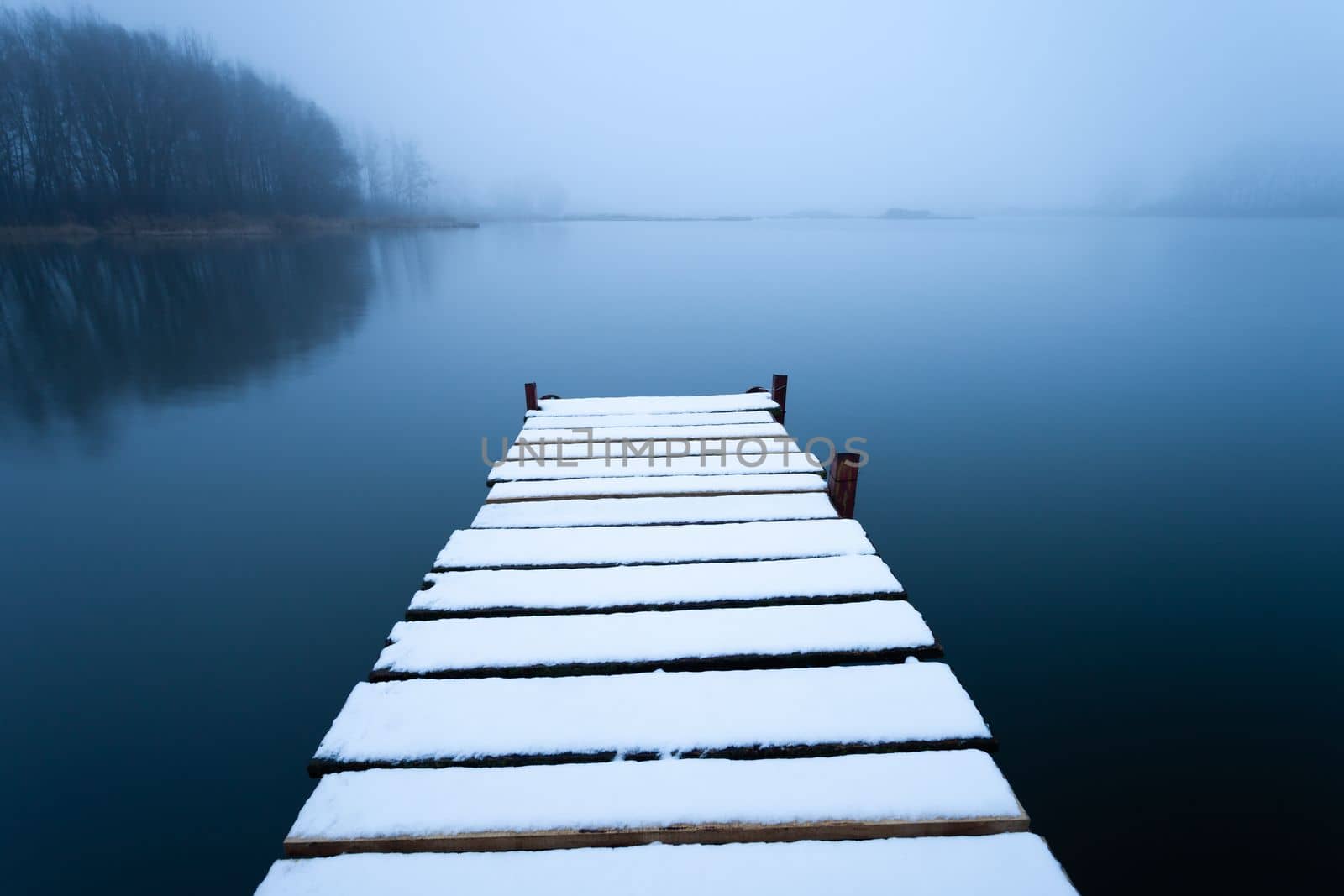 Snow on the pier and foggy lake, Stankow, eastern Poland