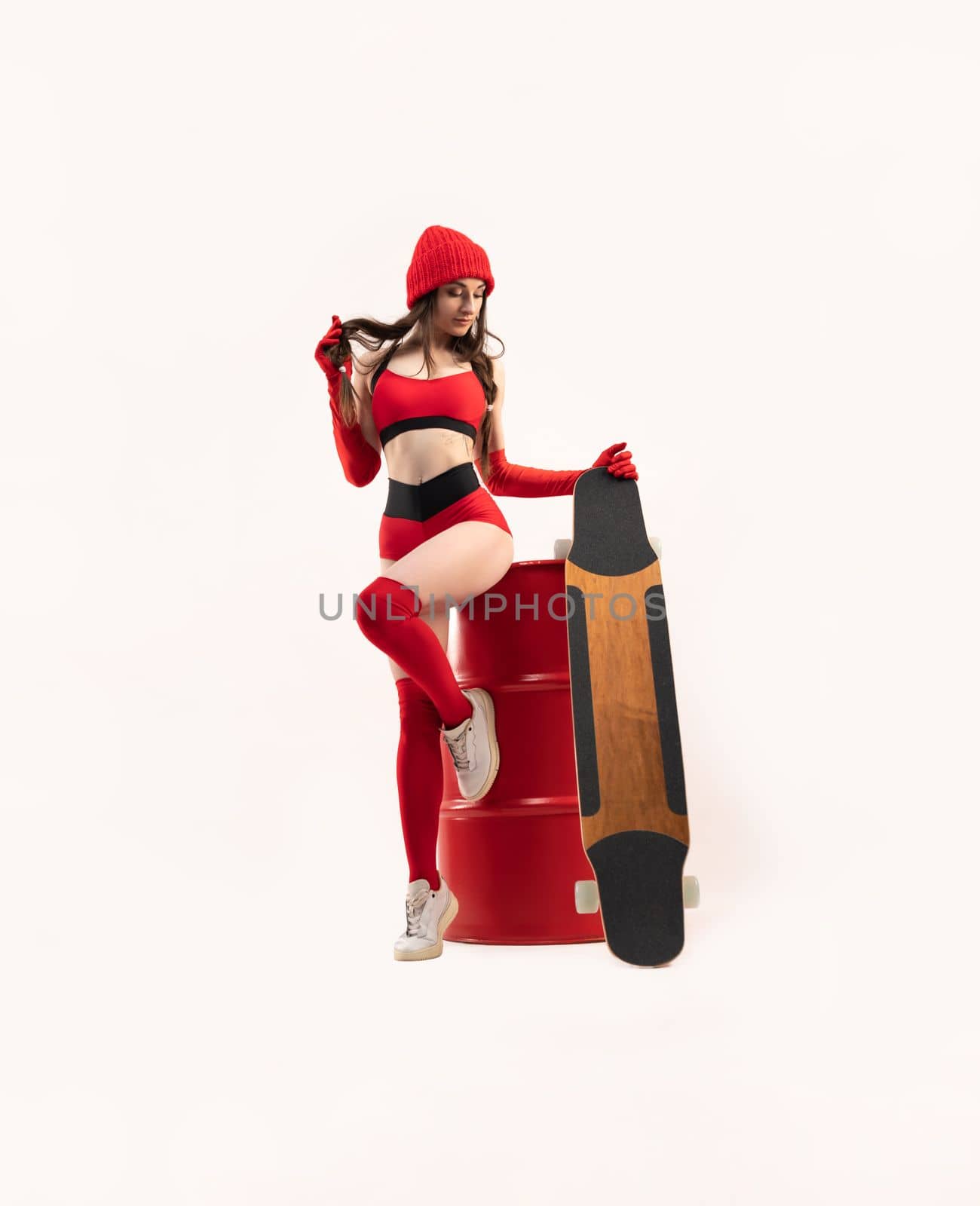 sexy girl with a longboard in short red sports clothes by Rotozey