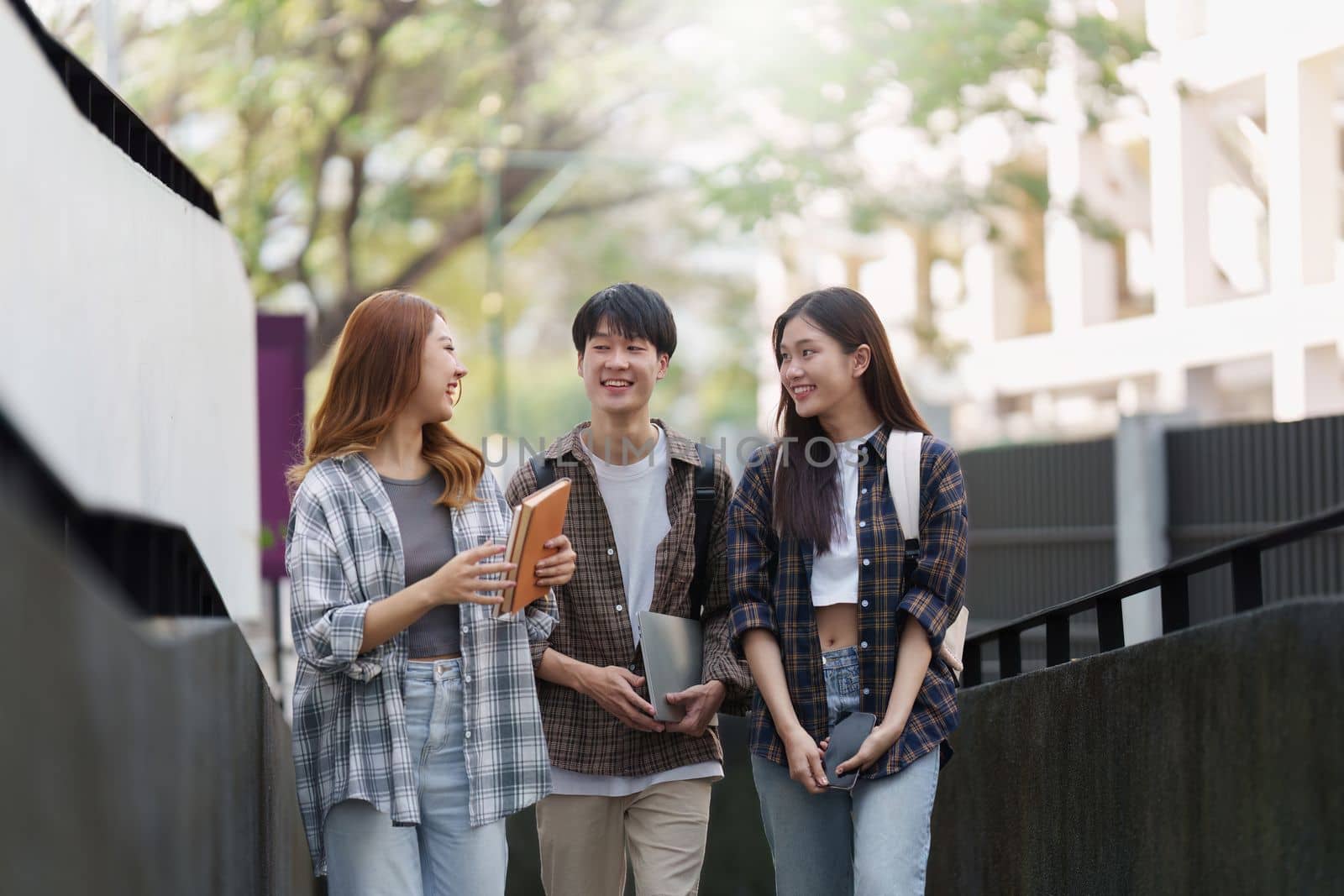 Group of Young Asian student walking and talking at university before class room. education, back to school concept.