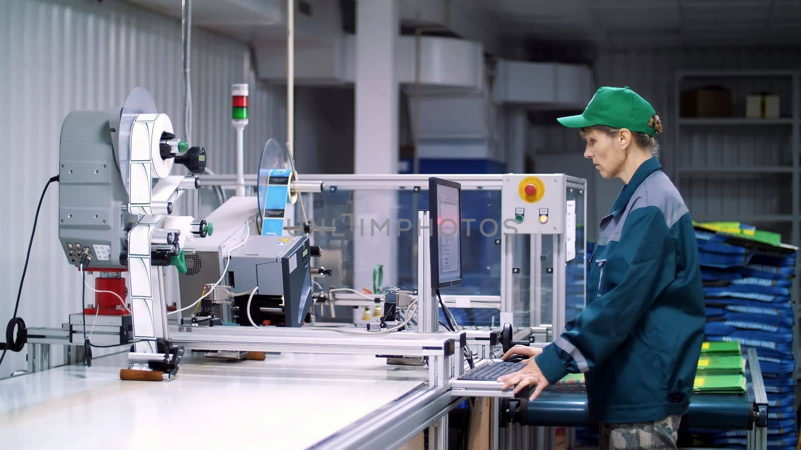 CHERKASY, UKRAINE - AUGUST 24, 2018: worker of printing equipment, adjusts, regulates the printing process. working process of printing packages for grain, agricultural products. High quality photo