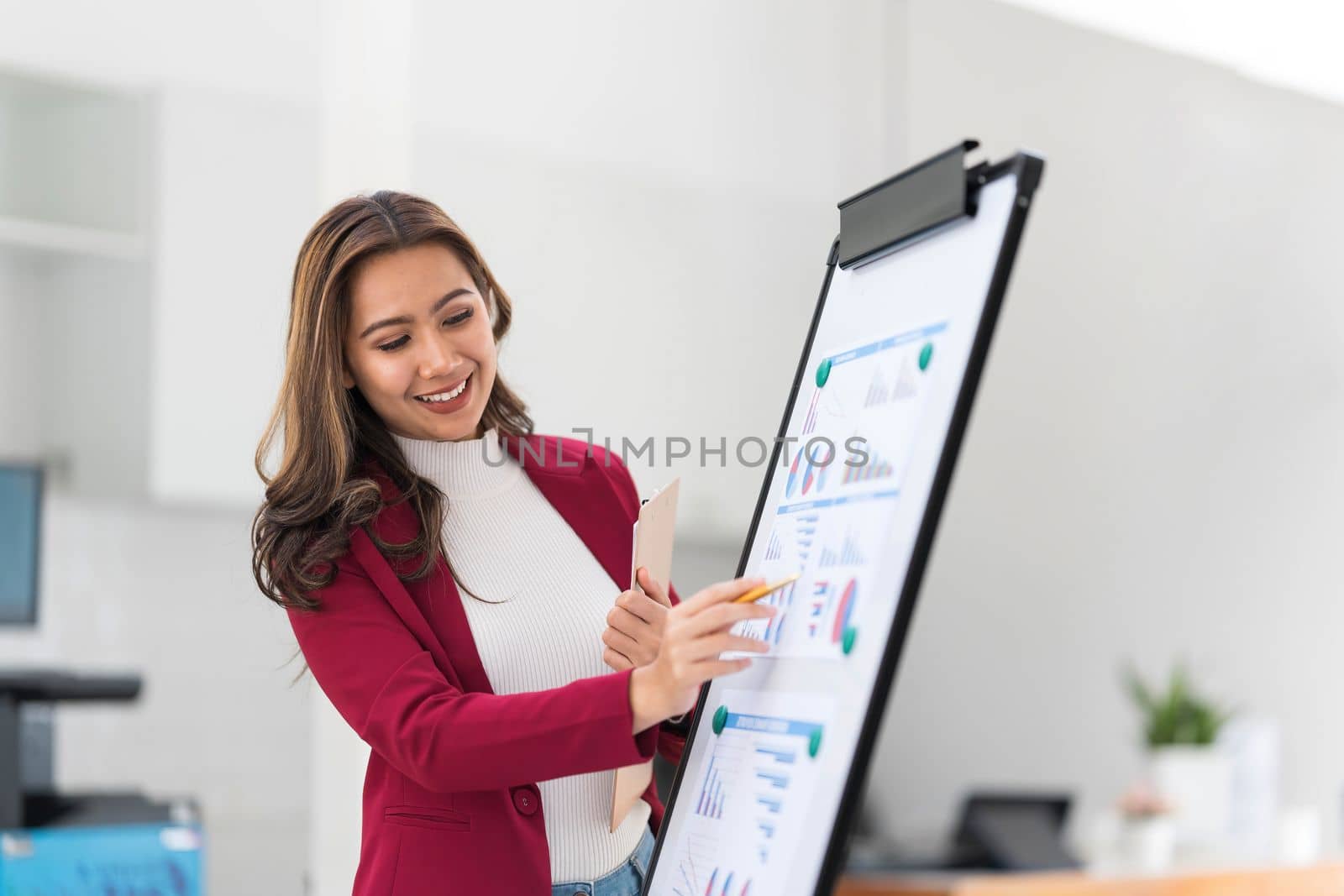 Portrait young businesswoman presentation marketing and profit with confident at office, investment and seminar for planning of finance, business woman standing explaining chart and graph...