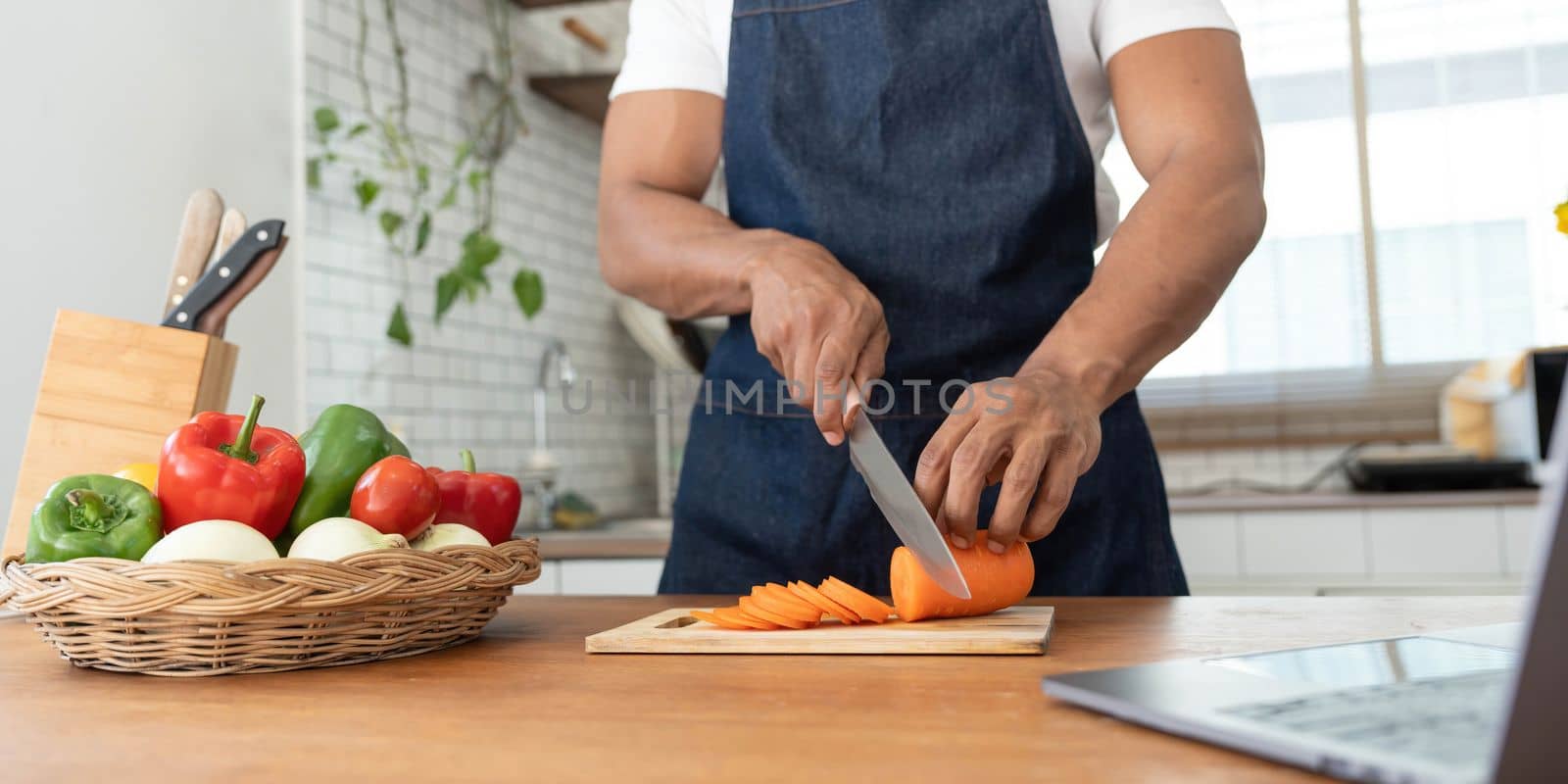 Closeup portrait of asian man making salad at home. cooking food and Lifestyle moment..