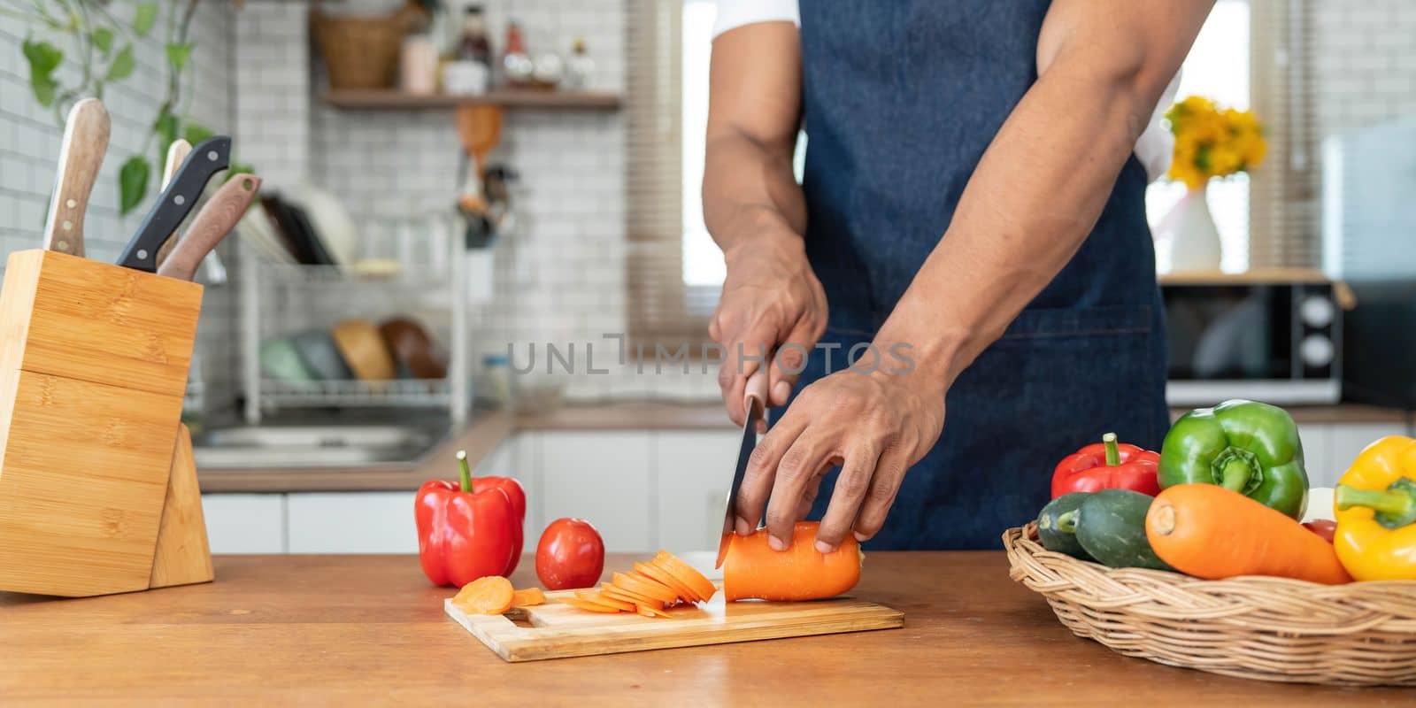 Closeup portrait of asian man making salad at home. cooking food and Lifestyle moment by wichayada